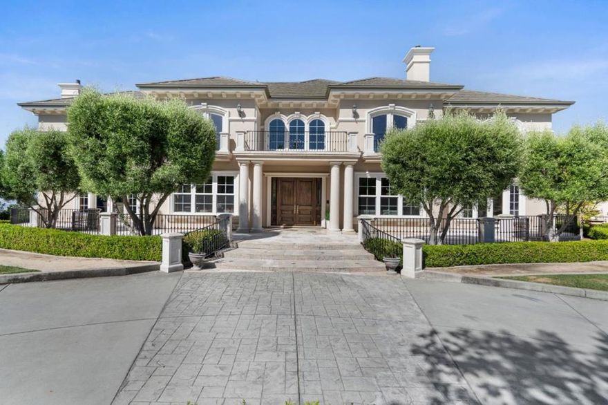 Aproximately 7,550 square feet of living space. Enter the grand foyer with soaring ceilings, sweeping staircase, Spanish limestone flooring, and tremendous natural light. This home showcases high-end appointments with detailed millwork, exquisite ceiling styles, elegant lighting, French doors, and balconies. Gourmet kitchen boasts custom cabinets, top-of-the-line appliances, dining area, walk-in pantry, wine cellar, and adjoining great room has unobstructed views from every corner. Retreat-like primary bedroom has a fireplace, generous walk-in wardrobe, and spa-like ensuite with soaking tub offering spectacular views, separate shower, and individual vanities. The formal living and dining rooms exude timeless sophistication while still offering inviting gathering spaces. Additional functional rooms include two laundry rooms, gym, hobby room, game room, office, and 5-car attached garage and workshop.Serene oasis with a fully landscaped, low-maintenance backyard, solar-heated pool, hot tub, and Italian travertine patio areas. A short distance to downtown Morgan Hill, restaurants, hiking and biking trails, wineries, top-rated schools, and easy access to Highway 101.