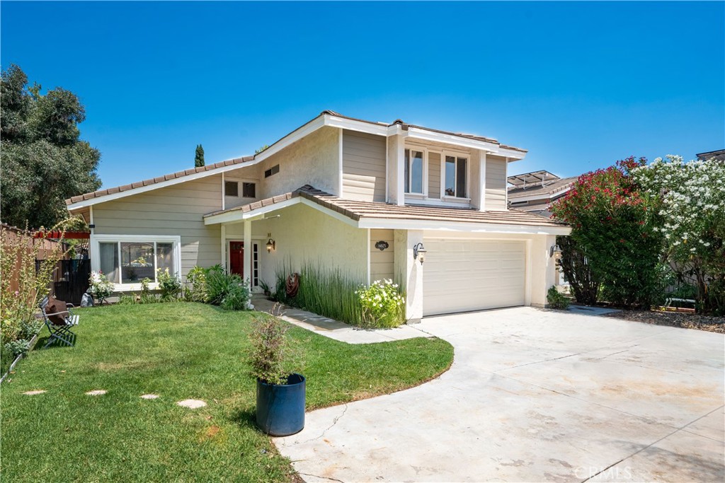 Talk about convenient! This awesome 4 bedroom home sits adjacent to one of SCV's best kept secrets (Begonias Lane Park) and has a gate for DIRECT access to the 4.6 acre park with basketball court, walking paths, playground, and picnic tables! Set back off the street on a shared driveway, the front of the property features a front yard with pull in parking spot for cars or RVs. Step inside and you'll find a gorgeous winding stairway. To the left the living/dining areas feature dual ceiling fans and vaulted ceilings. Rear kitchen features black stone counters, stainless double oven and cooktop, and a large bay window with a beautiful view of the backyard. Rounding out the downstairs layout is the dining nook and family room with fireplace. Upstairs you'll find all 4 bedrooms, all of which are able to accommodate large pieces of furniture! The garage has been modified to allow for a tremendous amount of storage and can easily be converted back to standard 2 car setup. The large backyard has a patio cover with plenty of room for seating and enjoying summer evenings while overlooking the pool size backyard. NO HOA, NO MELLO ROOS, and solar lease that is currently around 20 cents per kwhr, a pretty good deal! Get over to see it before it gets snapped up!