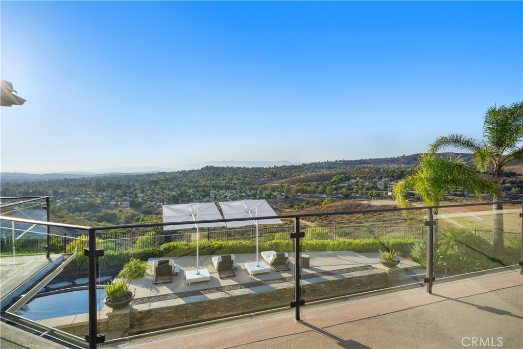 ***A Rare Modern Masterpiece with Breathtaking Views in North Pointe***
Nestled at the end of a quiet cul-de-sac behind the prestigious gates of North Pointe, this extraordinary 6,200 sq. ft. estate has been completely reimagined with the highest level of craftsmanship and design. Positioned on one of the most premier view lots in all of Westlake Village, the home offers complete privacy and truly panoramic vistas that stretch across the horizon.
The grand two-story entry, framed by sweeping dual staircases, welcomes you into a space where transitional modern elegance meets everyday functionality. The open-concept layout is ideal for both luxurious entertaining and relaxed daily living, featuring multiple sets of vanishing Fleetwood pocket doors that blur the line between indoors and out.
The home offers 5 spacious bedrooms and 7 bathrooms, including two luxurious primary suites—one conveniently located on the main level. A large guest suite has also been added on the first floor, perfect for hosting extended family or guests in comfort. Upstairs, a stunning primary retreat is accompanied by two en-suite bedrooms, a private office, a fully equipped gym/bonus room, and a state-of-the-art theater—each space offering unobstructed, explosive views.
At the heart of the home, the newly remodeled chef’s kitchen boasts dual oversized islands, premium Wolf and Subzero appliances, and seamless flow into the expansive family room. A temperature-controlled wine cellar, two full bars, and smart home integration complete the entertainer’s dream.
Step outside to resort-style grounds designed for unforgettable gatherings, featuring a custom pool and family-size spa, a massive covered patio, dramatic firepit lounge, and a one-of-a-kind outdoor kitchen equipped with every amenity—from a grill and pizza oven to a refrigerator, ice maker, and warming drawer.
Additional highlights include wide plank wood flooring, a three-car garage, a 3-zone HVAC system, fully owned solar panels, and a top-tier security and sound system throughout the property.
This is more than a home—it’s a lifestyle. A one-of-a-kind opportunity to own a view estate that delivers stunning design, modern amenities, and an unmatched Westlake Village location.