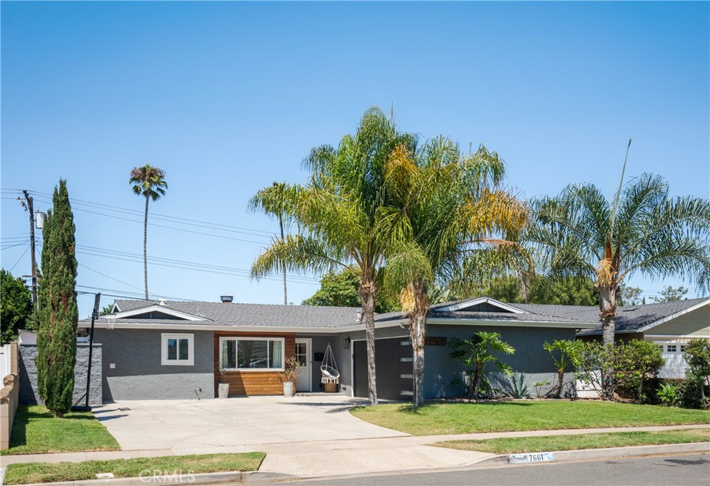 MODERN COASTAL LIVING MEETS TURN-KEY COMFORT & CHARM! Welcome to 7661 Ontario Dr, a rare find where every finish and feature has been carefully designed to balance sophistication and easy living. Step through the Dutch door of this remodeled home, and you’re greeted by a Venetian-plaster fireplace accented with a custom wood mantel and designer tile hearth. From here, the layout unfolds into an open concept, filled with natural light. The kitchen is a showpiece! The Café dual-fuel 6-burner double-oven range is surrounded by Quartz counters that flow into a full backsplash and extend to the peninsula island complete with bar seating and additional power outlets. Behind shaker cabinetry and gold-accent hardware, is a hide-away appliance center, pantry with pull-outs, and spice drawer to keep the space functional. A butler’s pantry adds more storage flexibility, while keeping the laundry area out of sight. Flowing through to the family room, a planked wood-beam ceiling, custom built-in entertainment wall with integrated storage and display lighting. The bedrooms include updated touches such as custom barn doors, hanging pendant-rope light, sputnik lighting, wainscoting, and panel-style doors with matte black hardware. Bathrooms feel spa-inspired, featuring rainfall showerheads, custom niches, quartz counters, vessel sink with wall-mounted faucet, storage mirrors, and water efficient fixtures. Retreat into the versatile sunroom where a plank ceiling, checkered tile floor, and built-in coffee/cocktail bar create a space suited for unwinding. From there, step out to the patio and backyard while palm trees sway above a landscaped yard with tropical plants, banana trees, and young avocado trees. Truly enjoy the privacy of the yard with a hot/cold outdoor shower that’s steps away from the surf shed. Additional features include luxury vinyl wood flooring throughout, recessed lighting with dimmers, direct access to the garage with a newer Cloplay door with MyQ technology, outdoor lantern lighting, dual-pane windows, a newer roof, paint, baseboards and gutters. As well as updated electrical panel/wiring and furnace, plus ongoing property maintenance. All of this is set on a palm tree-lined street just minutes from the beach, pier, Pacific City, and even closer is Terry Park, HB Central Park & Sports Complex, Five Points, and walkable to neighborhood favorites like Marios and Four Sons Brewing. This isn’t just a home, it’s a lifestyle!