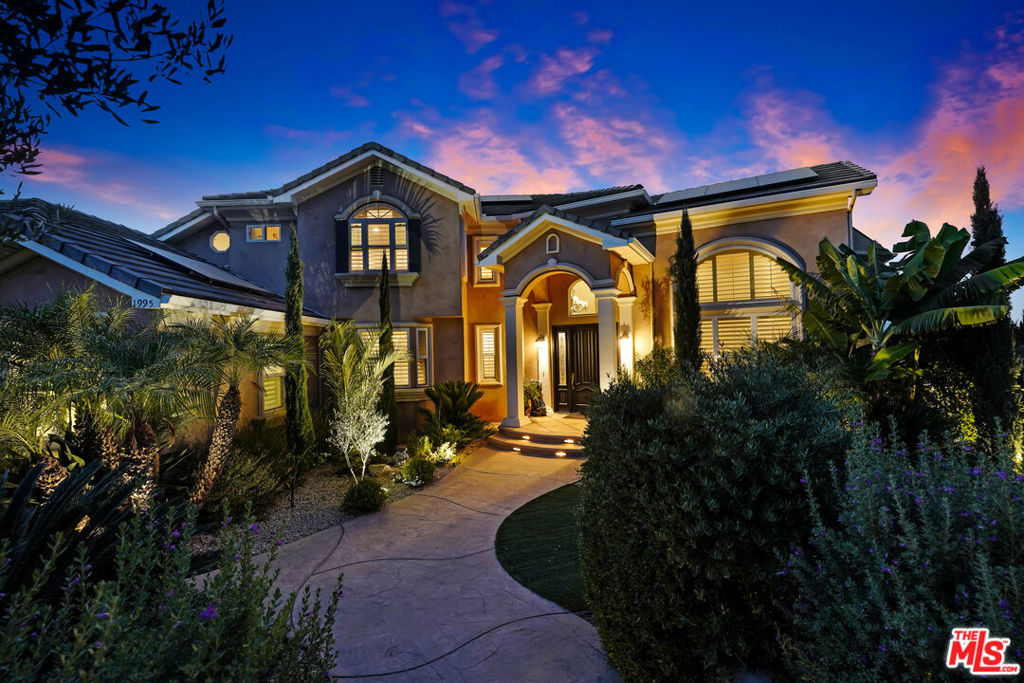 Stunning Mediterranean Hidden Gem! This exquisite custom home with views of Conejo Valley is set on a spacious 29,273 SqFt lot and showcases soaring ceilings and cathedral windows, providing an abundance of natural light through classic shutters. The gourmet chef's kitchen features a center island, granite countertops, stainless steel appliances, and a walk-in pantry, flowing seamlessly into the spacious family room. The luxurious primary suite offers a veranda with views, a bedroom fireplace, his-and-hers walk-in closets, separate his-and-hers toilet rooms, a soaking bathtub, and a glass-enclosed shower. On the lower level, a 530 SqFt mother-in-law studio with a private entrance includes an en-suite bathroom, kitchenette, and stackable washer/dryer. A bonus room above the garage offers large additional storage, accessible from the second floor. Enjoy the convenience of two 2-car attached garages and extra space for more vehicles in the driveway. Additional upgrades include a newer solar system, tankless water heater, dual-zoned AC, and a utility room. Step into a backyard paradisean entertainer's dreamfeaturing a newer saltwater pool and spa, luxurious outdoor living areas with multiple patios, and a spacious gazebo with a built-in barbecue, pizza oven, fireplace, and television. The meticulously landscaped grounds incorporate drought-tolerant plants, turf, and fruit trees. This is a rare offering of unique and exceptional estate!