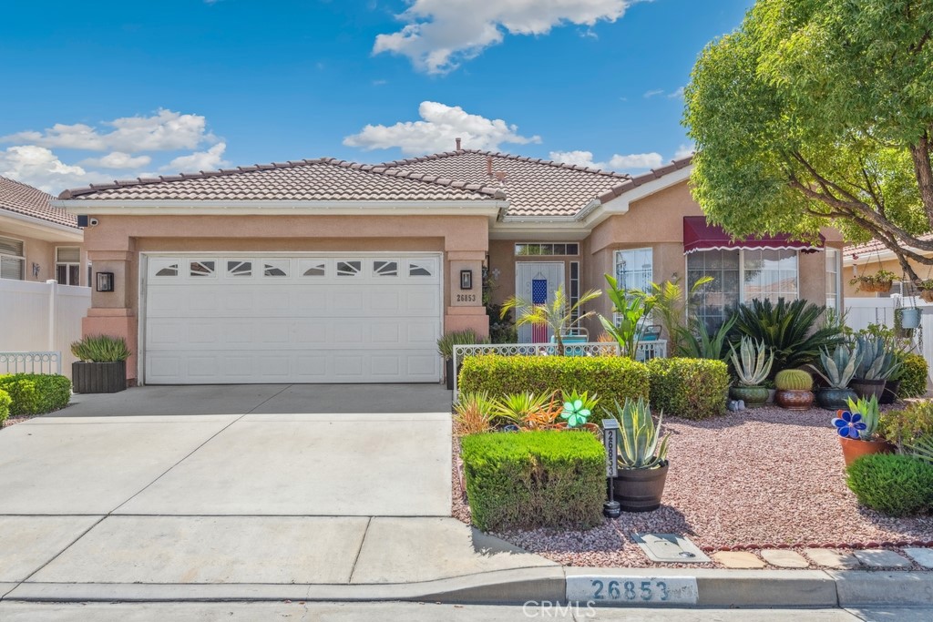 Located in the desirable gated 55+ community of The Club, this beautifully updated home features an outstanding front yard garden with low-maintenance landscaping, creating a truly special outdoor space. From the covered patio, enjoy breathtaking mountain views and spectacular sunsets—the ideal setting to relax or entertain. The home includes brand new solar (25-year), a new water heater, new garage opener, new LVP flooring, QuietCool whole house fan, and a new dishwasher. The kitchen has been recently upgraded with a new range-over microwave for added convenience and modern style. Go into a bright and fresh interior with high ceilings. The formal living and dining areas highlighted by a cozy fireplace. The spacious kitchen offers a center island, stylish tile backsplash, and opens to a flexible living/dining area with slider access to the backyard. The hallway leads to two bedrooms and two bathrooms, including a generous primary suite with dual closets and a large en suite bathroom with dual vanities. Enjoy the benefits of low HOA and low taxes. The Club community offers fantastic amenities including a clubhouse, pool, tennis courts, basketball, and a horseshoe area.