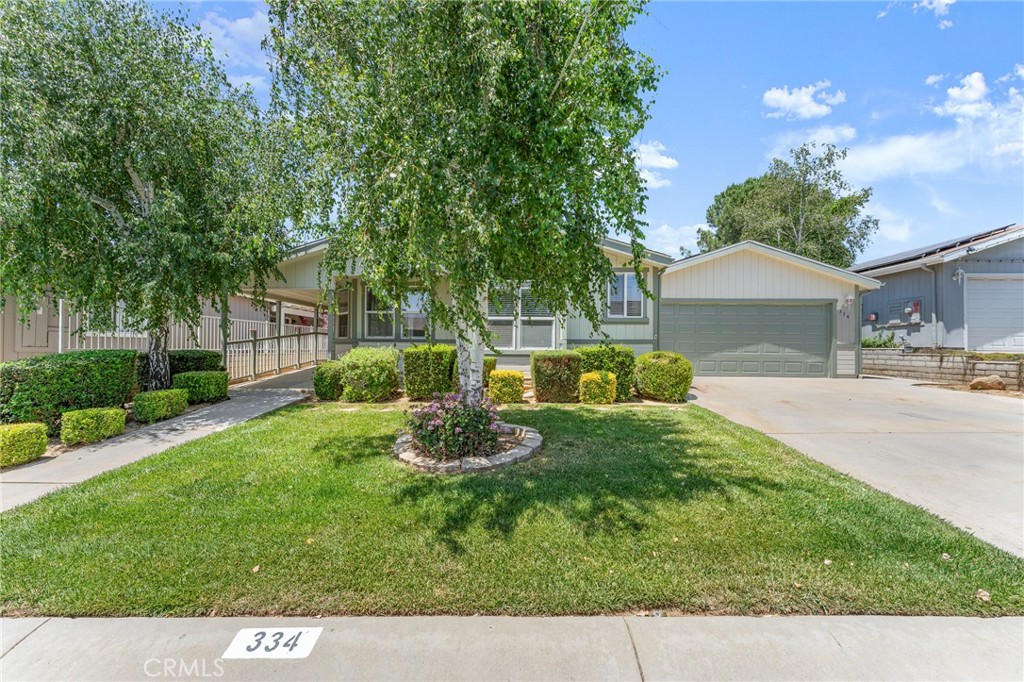 Welcome to this beautifully updated and meticulously maintained manufactured home in the highly desirable Plantation on the Lake—a 55+ resort-style community offering the perfect blend of comfort, and active living. This spacious 2,018 sq. ft. double-wide home features an open and airy layout with vaulted ceilings, skylights, and newer flooring throughout the main living areas. The inviting great room flows seamlessly into the dining area and spacious kitchen, making it ideal for entertaining. The kitchen offers ample cabinetry, counter space, and brand-new appliances. Recent upgrades include a new roof, fresh interior and exterior paint, and a new HVAC system—bringing peace of mind and energy efficiency. The oversized primary suite is complete with a large bathroom featuring a soaking tub, walk-in shower, and plenty of storage. A second generous bedroom and a hall bath with dual sinks provide excellent flexibility for guests. There is a large enclosed sunroom making the floor plan even more versatile. Step outside to your private backyard oasis with a covered patio, perfect for relaxing or enjoying morning coffee. The home also includes a 2-car attached garage and indoor laundry. Plantation on the Lake offers an incredible array of amenities, including: A beautifully appointed clubhouse with a full restaurant-style kitchen, Swimming pool, spa, and pickleball courts, Craft room with a ceramic kiln, Dog park, RV storage, and full-service dump station. This home offers the perfect opportunity to enjoy a low-maintenance lifestyle in a welcoming, active adult community.