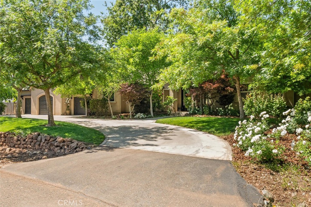 This is the home you’ve been waiting for!! The property is tucked away in a wonderful Chico neighborhood, featuring Rock Creek steps from your back patio. The property offers a blend of stunning home, privacy, and community. Inside you’ll be greeted by an inviting open concept floor plan will with lots of natural light. Admire the elegant details throughout, including beautiful coffered ceilings, crown molding and recessed lighting. The space has been upgraded with European white oak engineered hardwood flooring, new baseboards, and a custom 16-foot built-in entertainment center for a sleek, cohesive finish to the home. Enjoy the 180 views of your stunning backyard and of Rock Creek. The crisp, clean, and bright kitchen boasts built-in appliances, a large center island with a breakfast bar, and newly painted cabinetry with new custom-built all-wood drawers. The large master suite is a true retreat, featuring private access to the backyard, a double sink vanity, a large soaking tub, and a luxurious walk-in shower that doubles as a STEAM ROOM! This exceptional home also offers incredible amenities, including a convenient indoor laundry room with ample storage, an oversized 3-car garage, and RV parking. Peace of mind is ensured with a Honda generator for power outages and an efficient hybrid water heater. Plus, enjoy significant savings with OWNED solar! The outdoor space is an absolute oasis. Relax and unwind in the hot tub or gather around the plumbed fire pit on your patio while enjoying the tranquil sounds of Rock Creek flowing through your backyard. This is a rare find in a wonderful, hidden gem Chico location.