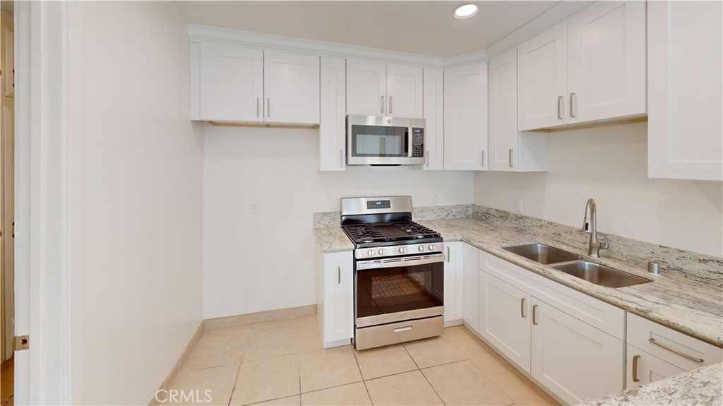 This single story/one level, 2 Bedroom, 2 Bath floor plan. Focused on comfort and energy efficiency, all windows are dual pane for lower utility bills. All stainless appliances and sink in addition to custom down lights and lighted ceiling fan in the dining area make cooking or relaxing in the kitchen/dining area a delight. A large window adds to its open and spacious atmosphere. Flooring within the unit is ceramic tile floors for easy cleaning while the living room and bedrooms are carpeted. Both bedrooms provide expanded windows, ceiling fans as well as mirrored wardrobe doors. The main bedroom also presents its own private bathroom. The second bedroom is conveniently located next to the guest bath. There is good cabinet storage in the hallway. Non Smoking unit, Small Pets will be considered, Landscaped Semi Private Fenced Front Yard, Privately Fenced Backyard w/Extended Patio accommodates outdoor furniture quite well, Stainless Gas Range & Microwave, Stainless Bosch Dishwasher, Ceiling Fans in Many Rooms, Dedicated One Car Space in a Shared Garage with an Additional Dedicated Assigned Parking on Property, W/D Hookups in Shared Laundry Room, Owner pays Water and Trash.