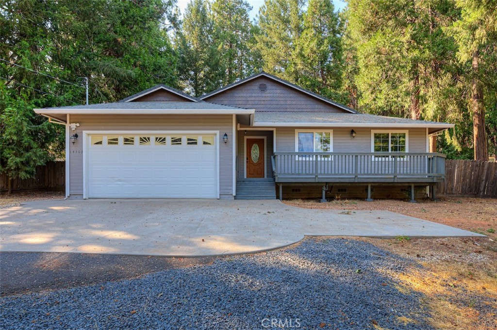 Welcome to 14503 Colter Way — a peaceful retreat where fresh mountain air offers a calming escape from the hustle and bustle. This charming 3-bedroom, 2-bath home features just under 1,600 square feet of comfortable living space, nestled on a spacious quarter-acre lot. Step onto the large front deck and take in sweeping views of the property — the perfect spot to relax and unwind. This open-concept home is truly turnkey. You’ll find the spacious layout both inviting and highly desirable, enhanced by vaulted ceilings that add to the airy and open feel. A cozy fireplace serves as a warm focal point, perfect for relaxing evenings. The home has been well-maintained, featuring fresh interior paint, water-resistant laminate flooring (installed in 2024), and brand-new carpet in the hallway and bedrooms. The well-designed kitchen offers an abundance of counter space and cabinetry, perfect for all your cooking and storage needs. Featuring recessed lighting, a newer range, built-in microwave, stainless steel double sink, newer dishwasher and refrigerator, and a charming atrium window that fills the space with natural light. The kitchen opens to the dining and living room, making it the perfect spot for gathering with family and friends. Another feature you'll appreciate is the easy-to-maintain landscaping, along with plenty of room for your RV and toys, plus ample parking with a large, spacious driveway. Truly a wonderful home—whether it’s your first or you’re looking to downsize. Call your favorite agent today to schedule a viewing of this charming property!