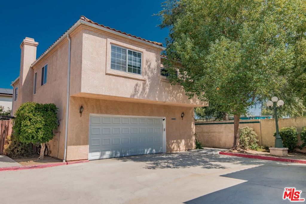 Fully detached North Hills home with 4 bedrooms upstairs plus a rare main-floor bedroom and full bath. Flexible layout perfect for guests, multi-gen living, or a private office. Situated on a corner lot with yard on three sides, the home enjoys extra privacy, mature fruit trees, and multiple outdoor spaces for entertaining. The backyard features covered patios with awnings, an above-ground spa (currently unhooked), and plenty of room to relax or garden. All within walking distance to shopping centers with grocery store, Starbucks, Walgreens, dining options, and right next door to an elementary school. Inside, a soaring two-story living room is anchored by a cozy gas/wood-burning fireplace. The updated kitchen boasts newer cabinets, countertops, and backsplash, plus a breakfast bar and charming greenhouse window over the sink. The dining area opens through sliding doors to the backyard, blending indoor and outdoor living.Upstairs, the oversized primary suite offers a retreat space, private balcony, and en suite with double sinks, soaking tub, and separate shower. Three additional bedrooms (two with their own shared balcony) share a full guest bath.The attached 2-car garage includes an overhead storage lift, large utility alcove, butler's sink, full-size washer/dryer, spare refrigerator, and abundant storage space. Additional features include a Nest system for modern comfort and efficiency.