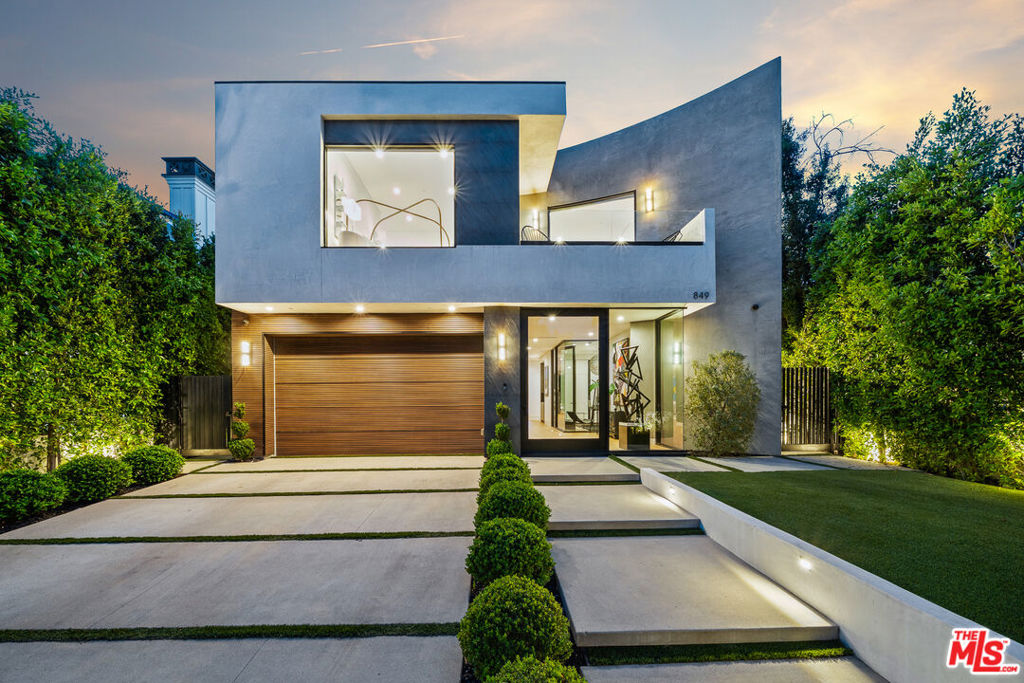 Experience the Top of modern luxury in this newer construction home in coveted Beverly Grove. Step inside to find an open-concept, light-filled space featuring striking natural stone finishes and wide plank wood flooring throughout. The Italian kitchen is ideal for hosting and includes marble waterfall countertops and world-class appliances. Indulge the indoor/outdoor lifestyle in the spacious living area with pocket doors opening to the resort style grounds. A floating staircase leads to the spa-inspired primary suite with a dressing room, 2-way fireplace, soaking tub, dual rain shower, and a private deck. Enjoy 360 city light views on the expansive rooftop deck, or entertain on the grounds with zero-edge pool and spa, fireplace, and outdoor kitchen. 3 additional en-suite bedrooms offer plenty of space, while a private office is ideal for remote work. Located just steps from L.As best dining and entertainment, this designer home redefines luxury cosmopolitan living.