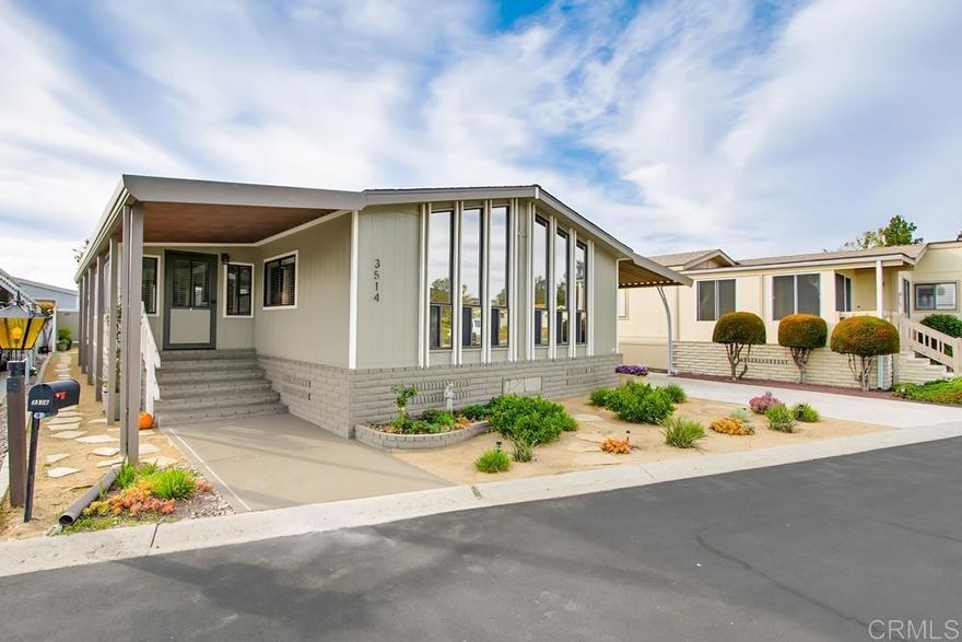 Welcome to one of San Diego North County's most sought after resort-style,  55+ communities that offers true coastal living with guard-gated security and land ownership.  The 433a was completed and recorded a couple of months ago by On the Level. Tucked away near the back of the neighborhood with no homes across the street, this peaceful and private location offers lovely views of the hills and Valdivia Vegetable Farm.  This meticulously maintained home boasts an open floorplan with vaulted ceilings and cathedral-style front windows that provide abundant natural light with solar tint for added privacy. The large kitchen features plenty of cabinetry for storage with quartz counter tops, newer appliances and upgraded fixtures. This area flows seamlessly into the formal dining and expansive living room perfect for hosting family and friends. A cozy den off the living room adds flexibility as a home office or craft room.  The expansive primary suite includes generous closet space with mirrored doors and a private updated en-suite bathroom featuring a newer vanity, marble countertop, custom tiled shower, and modern fixtures.  This home also features just off the kitchen, an indoor laundry space with plenty of extra cabinets for storage.  Additional improvements include a new roof, new HVAC system, new tankless water heater, vinyl plank flooring, fresh paint, crown molding, newer outlets & dimmer switches.  Step into to your enclosed sunroom that adds extra square footage to your living area and another ideal space for entertaining along with a sense of privacy.  A relaxing deck off the backside of the sunroom provides the perfect place to enjoy a quiet setting.  Step outside to a large carport with plenty of parking space that includes newer curved architectural supports, a concrete driveway extension and a fenced yard on all 3 sides for privacy.  The bonus feature that is included with this wonderful home is a spacious workshop that is already outfitted with electricity. This location is just a short walk from the dog park, tennis and pickleball courts.  Rancho Carlsbad  features lush landscaped grounds with ponds, wildlife, and charming bridges.  Other amenities of this community includes a public golf course with driving range, clubhouse, resort-style pool area, RV storage, fitness center, library, and countless activities to enjoy year-round with over 30 clubs to join to meet new friends!  This is a great opportunity to move into this coveted community.