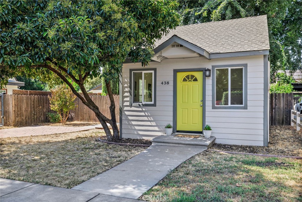 Fall in love with this storybook cottage the moment you step inside its sunny yellow door! You will find this cutie in the highly sought-after Avenues, just around the corner from Enloe Hospital & Chico State University! This absolutely adorable 2-bedroom, 1-bath, 775 sq foot cottage is brimming with charm and character with thoughtfully designed space. The sunlit front room welcomes you with beautiful hardwood floors and fresh interior paint, while the kitchen shines with a brand-new backsplash, freshly painted cabinets in a cheerful pastel sage green. Plus there are many pull out drawers in the kitchen cabinets for ease of use and for those chefs, there is a great gas range! To maximize your energy efficiency, there are 3 mini split units that you can use to zone the homes different spaces! Hall closet conveniently provides space for a stackable washer/dryer. The single bathroom has two access doors, one from the hallway and one from the 2 bedroom. Primary bedroom has beautiful, engineered hardwood floors with a luxurious walk-in closet and even its own access to the backyard deck! Outside, you’ll find your own private retreat—soaring, mature shade trees, a fully fenced backyard, and a spacious Trex deck perfect for morning coffee or evening get-togethers. The backyard is surprising a spacious size allowing for a large garden, tons of room for kids to play in or? Siding of the home is all Hardie Plank Lap Siding (fiber cement siding) which is known for its durability. A matching storage shed adds functionality and flair, featuring the same bright, happy yellow doors as the home’s front door, tying the whole property together with delightful curb appeal. Whether you’re a first-time buyer, downsizing, or looking for a prime location near downtown and the hospital, this cottage offers the perfect blend of comfort, style, and convenience—making it a rare find you won’t want to miss!