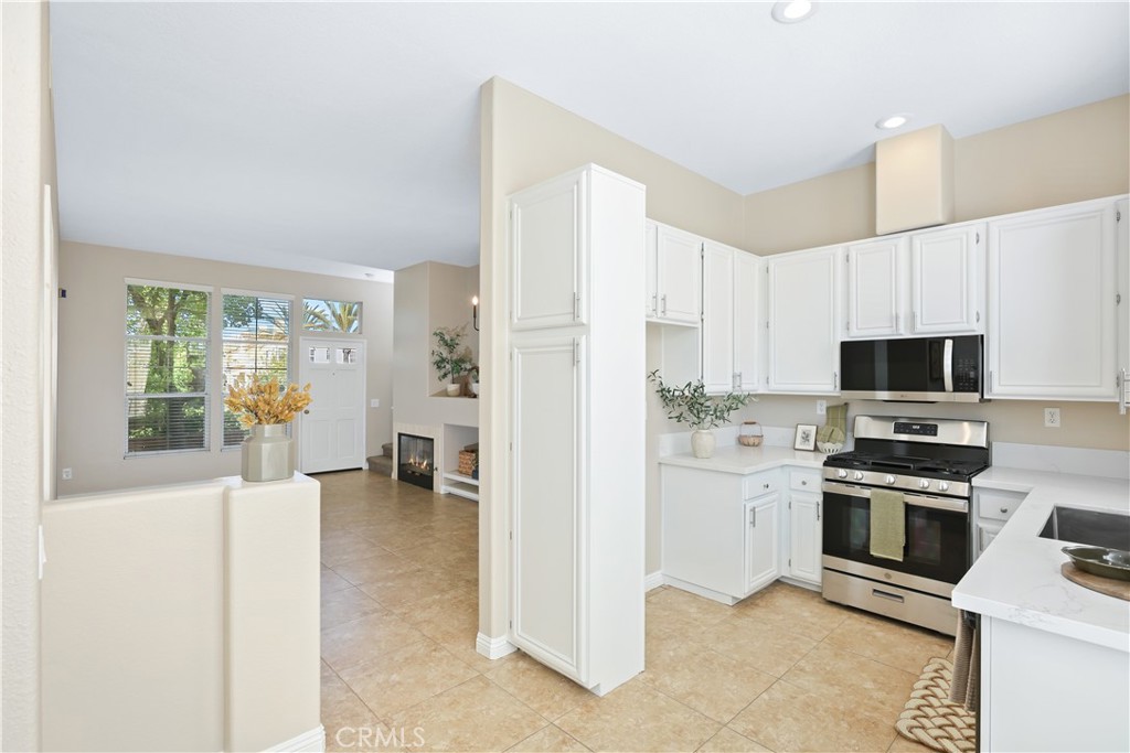 Welcome to your Pinterest inspired condo in Anaheim Hills featuring 2 bedrooms, 2 1/2 baths, and 1035 SQFT of living space in the gated Summit Renaissance community. The kitchen has been recently remodeled with bright white cabinets, quartz countertops, a new stove, microwave, stainless steel sink & faucet. Across from the kitchen, you’ll find a convenient remodeled desk/work station, for a home office or study area. The interior of the home has been freshly painted in "accessible beige" from the Sherman Williams collection, giving it a modern and clean look. A new chandelier has been added to brighten up the room.
Upstairs, both bedrooms have an en-suite bathroom with cabinets updated in Sherman Williams "naval" blue with new lighting fixtures to enhance the space. Direct access to a 2-car garage with laundry hookups offer added convenience. Relax & unwind on the front patio with enclosed gate. Situated in a premium location, this property offers resort style living with a sparkling pool, workout room & guest parking close by.
Love living in Anaheim Hills as you enjoy this turnkey condo with no one above or below you & conveniently located near shopping centers, highly rated schools & parks. This is HOME.