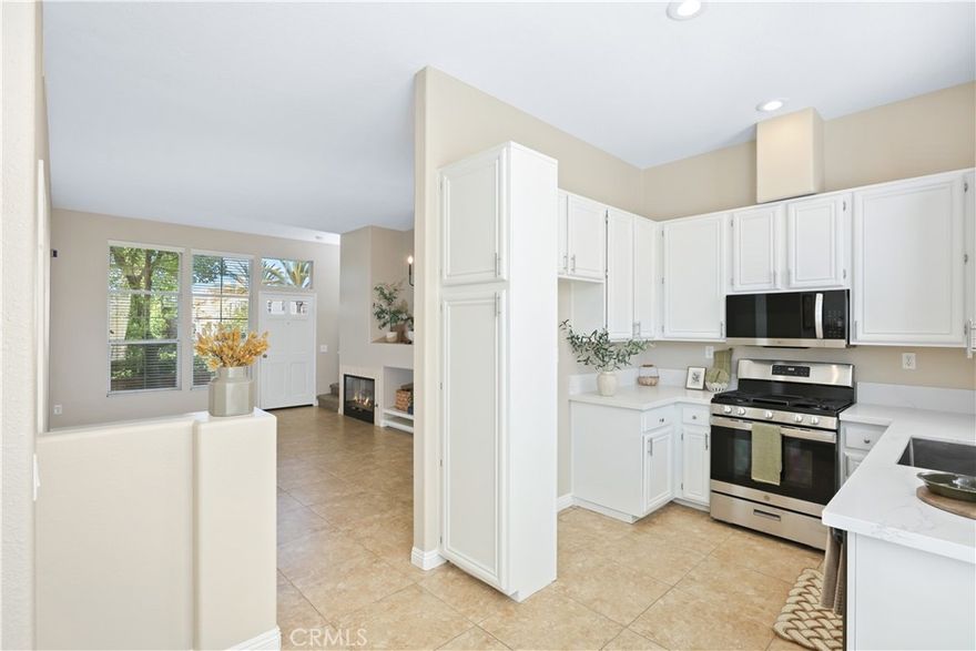 Welcome to your Pinterest inspired condo in Anaheim Hills featuring 2 bedrooms, 2 1/2 baths, and 1035 SQFT of living space in the gated Summit Renaissance community. The kitchen has been recently remodeled with bright white cabinets, quartz countertops, a new stove, microwave, stainless steel sink & faucet. Across from the kitchen, you’ll find a convenient remodeled desk/work station, for a home office or study area. The interior of the home has been freshly painted in "accessible beige" from the Sherman Williams collection, giving it a modern and clean look. A new chandelier has been added to brighten up the room.



Upstairs, both bedrooms have an en-suite bathroom with cabinets updated in Sherman Williams "naval" blue with new lighting fixtures to enhance the space. Direct access to a 2-car garage with laundry hookups offer added convenience.  Relax & unwind on the front patio with enclosed gate. Situated in a premium location, this property offers resort style living with a sparkling pool, workout room & guest parking close by.



Love living in Anaheim Hills as you enjoy this turnkey condo with no one above or below you & conveniently located near shopping centers, highly rated schools & parks. This is HOME.
