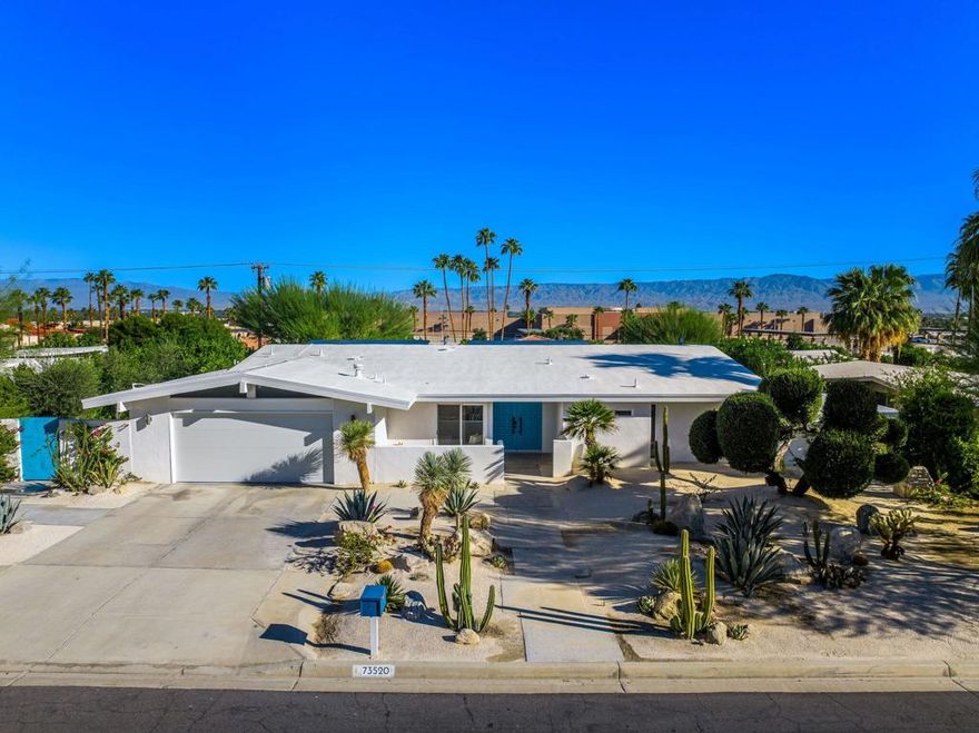 73520 Joshua Tree Street is a fully remodeled mid-century residence in South Palm Desert, nestled in a quiet, secluded neighborhood with sweeping mountain views and just blocks from El Paseo's premier dining, shopping, and cultural attractions. The home seamlessly combines modern finishes with carefully restored vintage details, preserving its architectural integrity while offering contemporary comforts for sophisticated desert living. Inside, polished concrete floors flow throughout the open-plan living, dining, and kitchen areas, which are anchored by a large kitchen island with eat-up seating, perfect for entertaining or casual gatherings. A dramatic wall of glass opens these spaces to a raised backyard terrace, creating a seamless connection between indoors and outdoors and framing scenic mountain vistas. Thoughtful spatial planning enhances both flow and privacy, ensuring that each area of the home feels purposeful and inviting. The primary suite and den occupy one wing of the home, while two guest bedrooms are positioned on the opposite side, providing separation and privacy. Multiple rooms open to patios or terraces, reinforcing the home's bungalow-like ease and celebrating the hallmark indoor-outdoor lifestyle of Palm Desert living. The tiered backyard is designed as a private retreat and entertainer's playground. A pool and spa are complemented by 2 outdoor showers, a fire pit, outdoor sauna, and expansive terrace spaces for lounging or dining al fresco, all surrounded by mature, low-maintenance landscaping. Additional highlights include a fully finished two-car garage with epoxy floors, restored original front doors with bronze hardware, owned solar, and a cohesive blend of modern and vintage design elements that convey a refined sense of style. Blending timeless mid-century character with contemporary sophistication, this residence offers elevated design, thoughtful indoor-outdoor integration, and easy access to El Paseo's lifestyle amenities, making it an exceptional opportunity for those seeking refined desert living in a serene South Palm Desert setting.