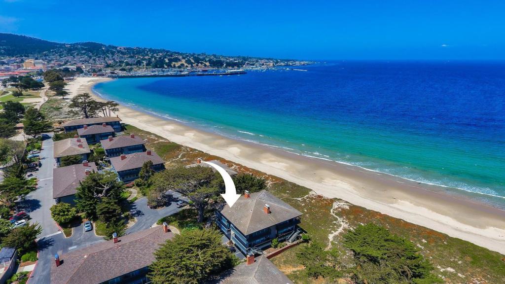 Welcome to 36 La Playa Street, where modern design meets beach living just 20 steps from the sand. This stylish, oceanfront townhouse offers 1,156++ sq ft of light-filled space and is perfectly positioned as 2nd of just two front-line units, offering rare, unobstructed southwest-facing views of Monterey Bay from the main living area & primary suite. With 2 bedrms, 2.5 bathrms, & 3 well-designed levels, its currently a thriving long-term Airbnb retreat. The 2021 remodel blends casual coastal charm with updated touches featuring quartz kitchen counters, new appliances, luxury plank flooring, & an open-concept living space with a cozy fireplace. The lower-level bonus room (not included in sq ft) is an ideal guest retreat or family hangout, offering bunk beds, lounge space, laundry area, & extra storage. Plenty of parking. BONUS: Sold FULLY FURNISHED w/ tasteful, beach-inspired decor ~ making it truly turnkey & ready to enjoy or rent immediately. Whether you're seeking a personal beachfront escape or a proven income-producing property, this home checks every box. Savor the sound of waves, sunsets, & morning strolls. Easy access to Hwy 1, shops, dining, & the wharf. Seller intends to perform 1031 exchange at no cost to buyer. Buyer cooperation requested.