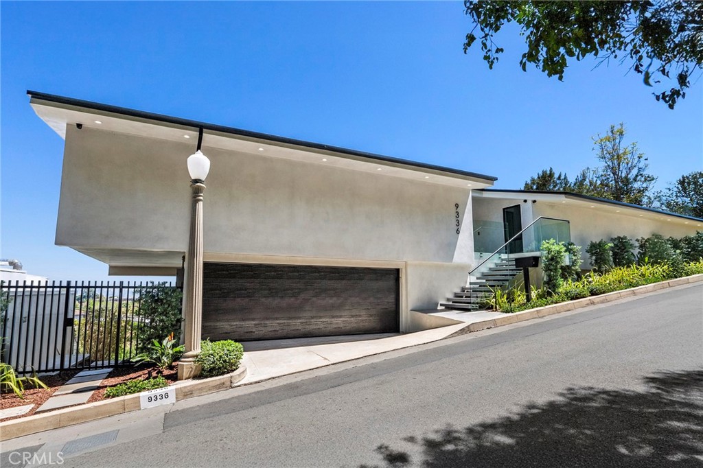 Stunning, newly-completed gut renovation of a 1960 mid-century modern home near the top of the coveted Crest Streets in Beverly Hills. The property features jetliner views of the Los Angeles basin from Downtown to Century City with Trousdale Estates, Billionaire’s Row, and Sierra Towers in the foreground. Designer-selected finishes with Italian cabinetry, European oak floors, an impressive pivot entry door and a Thermador integrated appliance package—all executed by NA Build Design with unparalleled attention to detail. Massive step-down living/dining room with a linear fireplace wrapped in stone opens to a covered terrace through floor to ceiling glass with Fleetwood sliders. Adjoining third bedroom, den or office (owner will add closet if desired)and separate casual dining area or den with floor to ceiling windows. Huge primary bedroom with fitted closets, sitting area, well-appointed bath and jaw dropping views. Location convenient to the Sunset Strip, Beverly Hills restaurants & shops, UCLA and Century City. Single loaded portion of Lloydcrest Drive with wide street frontage. Two-car garage with utility/storage room and driveway parking for one additional car. Fully wired for sound and security camera system already in place. The property is also available immediately for long-term lease. Easy to show.