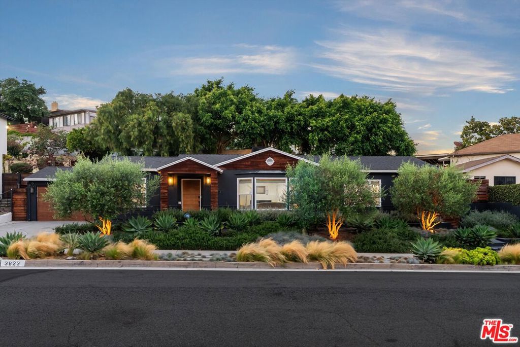 Welcome to 3823 Lorado Way, where timeless character meets modern sophistication in iconic View Park. A canopy of mature trees and sculpted native landscaping, lavender, ornamental grasses, crushed stone paths sets the stage, framed by charcoal stucco and a warm wood front door. Inside, a luminous open layout unfolds across wide-plank white oak floors, with designer lighting, a stately stone fireplace, and natural light pouring through oversized picture windows. Built-ins, dinning room, and matte-black accents add texture and charm. The chef's kitchen stuns with Calacatta quartz counters, a waterfall island with bar seating, subway-tile backsplash, and premium stainless appliances. A cozy den leads to the backyard: multi-level patios, drought-tolerant plantings, a custom gas fire pit with built-in bench, and a storybook gazebo beneath blooming trees. The primary suite offers direct yard access and a spa-style bath with marble chevron floors, freestanding tub, and floor-to-ceiling tile. Two additional bedrooms, including one with an en-suite bath, complete the layout. Modern upgrades include a whole-home Puronics water-filtration system and 240V EV charging outlet in the garage. Zoned for Cowan Elementary and ideally located near some of the most beloved spots in View Park and neighboring West Adams, the home sits at the heart of a thriving, connected community. Spend mornings at Hilltop Coffee, a welcoming local cafe perfect for brunch, remote work, or casual catch-ups, then return on the third Thursday of each month when the space transforms into Jammin' on the Hill, a lively evening of music, food, and community connection. Around the corner, Simply Wholesome has been a neighborhood anchor since 1984, offering health-conscious meals, natural supplements, and fresh juices in a vibrant, Caribbean-influenced setting. For live jazz and Creole cuisine classics, La Louisiana's serves Po' boys, catfish, and jambalaya alongside nightly live music Wednesday through Sunday. For an elevated night out, Somerville offers a progressive American dining experience that highlights contemporary cuisine while honoring the rich roots of South Central Los Angeles. Intentionally located along the Slauson Corridor in Historic View Park Windsor- Hills, Somerville is an ode to the past, a toast to the present, and a celebration of the progress in between. And just a short drive away, the new Whole Foods on Jefferson provides everyday convenience right next door to Sandbox VR, a state-of-the-art virtual reality destination that's become a favorite for immersive group fun. Don't miss your chance to own a thoughtfully updated home in one of LA's most historic and vibrant communities. Schedule your private tour today and experience the lifestyle that only View Park can offer.