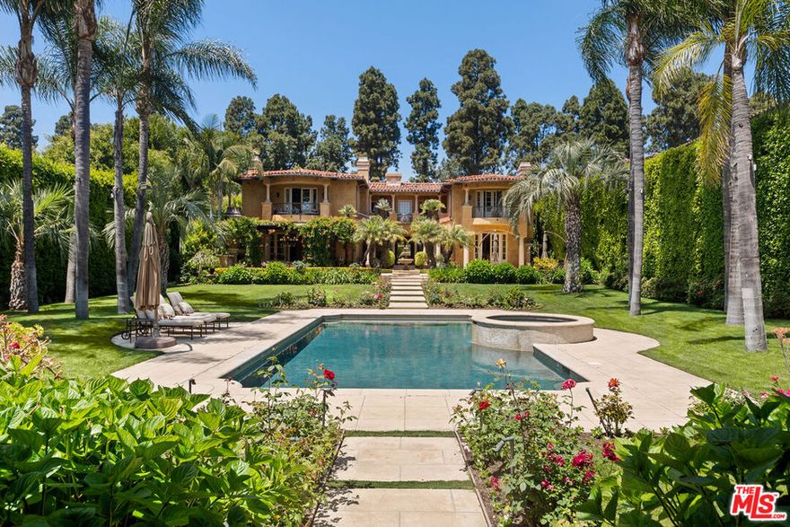 This extraordinary gated Mediterranean estate is a true sanctuary of elegance and scale. Encompassing over 31,000 square feet of impeccably manicured flat grounds, the property is enveloped by mature hedging that ensures complete privacy. Beyond the stately entrance, a dramatic two-story foyer reveals twin sweeping staircases and an array of refined living and entertaining spaces.  Highlights include a formal dining room with custom wine storage, a gourmet chef's kitchen built for culinary excellence, and a state-of-the-art home theater. Every detail reflects exceptional craftsmanship and curated designer finishes. The main residence features seven bedrooms and six bathrooms, including two guest suites conveniently located on the first floor. Upstairs, the primary suite is a luxurious private haven, offering dual spa-inspired bathrooms and expansive dressing rooms reminiscent of a couture atelier on Rodeo Drive. A detached one-bedroom, one-bathroom guest house provides flexible accommodations for guests or staff.The grounds offer a peaceful escape, with a tranquil fountain, vibrant rose gardens, multiple loggia-covered seating areas, an outdoor fireplace, and an elegant alfresco dining pavilion designed for unforgettable gatherings beneath the California sky.With parking for eight vehicles, exceptional privacy, and close proximity to Beverly Hills' top-rated schools, civic amenities, and world-class shopping and dining, this is one of the city's most distinguished luxury lease offerings.