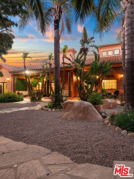 This Malibu Hacienda Farm with wonderful views of the surrounding hills and ocean sits on approximately 10 spectacular acres. Rolling terrain makes it an ideal property for farming and/or horses. There are 4 bedrooms, a loft, and 4 bathrooms. French doors open to several outdoor patios and alcoves where one can enjoy this botanical oasis in the hills of Malibu. Vaulted ceilings throughout. Mature landscaping throughout the property includes palm trees and a wide variety of fruit and avocado trees. The acreage embraces large-scale entertaining & recreation with room for over 125 cars and privacy abounds. This estate offers a haven of natural privacy & is an ideal retreat away from the hectic life of the Metropolis and far from neighbors. Frolic in the pool or play Bocce ball in the private court next to the area where weddings could be held. RV's can be accommodated on this property. Only about 10 minutes to the beach and 12 minutes to the Tranca's grocery store and 15 minutes from Westlake the property offers a variety of daily destinations. Enjoy wine tasting in this Malibu Wine destination location.