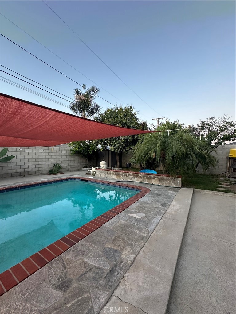 Ready for poolside summer days? This welcoming 4-bedroom, 2-bath home in Azusa has everything you need to kick back, spread out, and enjoy! With plenty of space inside and out, it’s perfect for families, entertainers, or anyone looking for a comfortable place to call home. Step inside to a spacious living room with a cozy fireplace, plus a second family room that opens to the backyard, great for movie nights or hanging with family and friends. The kitchen has a classic galley layout with easy flow to the dining area, making meals and get-togethers a breeze. Out back, you will love the privacy and the low maintenance landscaping, a few fruit trees and a sparkling pool that's just calling your name. There's also an attached 2 car garage with laundry hookups, and a water softener system that's practically brand new. Located in a prime location near schools, shops, dining, and major freeways (605,10,210), this home checks all the boxes. Come see it for yourself, your summer starts here!!