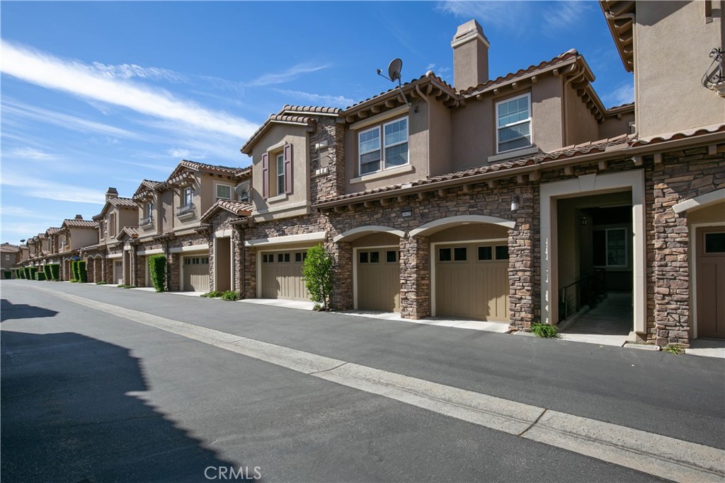 Welcome to this beautifully designed 2-story townhome offering 3 spacious bedrooms and 3.5 bathrooms. The open floor plan is filled with natural light, creating a warm and inviting atmosphere throughout. The modern kitchen boasts granite countertops, stainless steel appliances, and ample cabinetry, perfect for cooking and entertaining. All bedrooms are conveniently located upstairs, along with a laundry room for easy access. The primary suite is a true retreat, featuring a large en suite bathroom with double vanities and a walk-in closet. Enjoy the convenience of an attached 2-car garage and a private walkway leading up to the front door. Relax and unwind by the resort-style pool while taking in breathtaking views of the valley. Conveniently located near the 118 freeway.