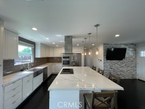 This single-story residence is where comfort meets coastal convenience, just 2.8 miles from the shores of Huntington Beach. The updated home greets one with a fully fenced front yard, offering a spacious lawn for one to enjoy. A two-car garage provides ample parking and includes a washer and dryer for added convenience. The front porch is an ideal spot to begin the morning with a cup of coffee or wind down in the evening. Upon entering, one is welcomed by an open-concept living area filled with natural light and warmth. The kitchen has a spacious island featuring an electric cooktop and seating area- perfect for gathering and sharing meals. With cabinetry, a built-in oven, dishwasher, beverage fridge and refrigerator included in the lease, the space blends practicality with comfort. From the kitchen sink, one can look out the window to the backyard, where an above-ground jacuzzi invites relaxation. The hallway leads to two comfortable bedrooms and a well-appointed bathroom, while the primary bedroom offers the comfort of a private en-suite bath. Ideally located near the Seal Beach National Wildlife Refuge, Marina Park, and within walking distance to Village View Elementary School, this home offers both tranquility and connection to the best of coastal living.