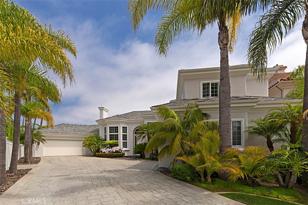 Premier Ritz Cove Oceanfront community in Dana Point, California awaits you with 24-hour guarded gates. This private estate is located at the end of a cul-de-sac with 4 bedrooms 4.5 bathrooms and a Master Suite on the main level. Marble flooring and an impressive entry with over 15 foot ceilings is only the beginning of your journey. Enjoy the family room, bonus room (could be 5th bedroom) and custom built office. Every bedroom encompasses its own retreat with full bath and walk-in closet. The spa and waterfall invite you to outside where you can entertain friends & family with a custom bbq and outdoor shower to rinse off after a day at Salt Creek Beach. A 4-car garage with epoxy flooring, storage and a separate spacious work room with built-ins for any enthusiast. Ideal home for Coastal Living!