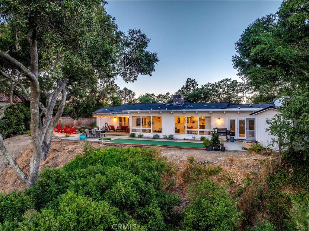 Welcome to 5355 El Verano Ave, a one of kind property with stunning views. Completely remodeled, this single story 4-bedroom, 2 bath, 2,424 sqft home is perfectly situated on an oak studded hilltop one acre lot. Upon entering the home you’ll see a peak of the views from the entry pulling you toward the living room & kitchen. But as you proceed toward the views, you’ll notice the exquisite remodel and attention to detail with crown molding, solid core interior doors, high end 8” plank vinyl flooring and recessed lighting throughout the entire home. From the entry on the left through beautiful double French doors is a spacious office/den or guest accommodations. The hallway begins on your right with the custom guest bath complete with a quartz countertop vanity and custom tile shower. Three spacious bedrooms are located down the hall with the primary suite offering a walk-in closet, additional double closet, exterior double French doors leading to the covered deck and located facing East to enjoy the amazing sunrises that occur throughout the year. The primary bath includes an amazing soaking tub, spacious tiled shower, quartz counter tops and dual sinks. From the entry and hallway, the view begins to present itself leading you into the heart of the home where the custom kitchen opens to the living room and dining area with large picture windows showcasing the spectacular views of the Salinas River Valley. The custom kitchen offers quartz countertops, a spacious island with bar seating, stainless-steel Kitchen Aid appliances that include a double oven, dishwasher, 4-burner stove with a griddle & grill all complimented by a retractable wall mounted pot filler nicely situated with the subway tile backsplash. The dining area is just off the kitchen with a built-in cabinet with quartz countertop and two generous wine refrigerators. Adjacent to the dining area is the movie room or fourth bedroom with digital 7.1 Dolby sound. Additional amenities include covered RV parking, owned solar, oversized 2-car garage with built-in cabinets and work bench, custom concrete basketball area with top-rated outdoor hoop, putting/chipping green, newer HVAC, all new electrical & plumbing, dog kennel, and detached shed that could be an office. This property offers a comfortable lifestyle with privacy, amazing views, all within walking distance (1 mile) to the new revitalized Atascadero downtown where you can enjoy nice restaurants, music, and the sunken garden farmer’s market.