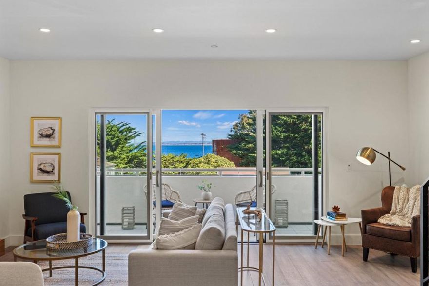Step into supreme luxury just one block behind fabled Cannery Row on the Monterey Peninsula. This state-of-the-art radiates contemporary chic, sporting lustrous, high-end finishes throughout two upstairs bedrooms, a spa-like primary bathroom, and a bright, open kitchen that flows directly into a living and dining area. Unit 1 truly offers the best of the best: Laminam Statuario Altissimo countertops, Thermador appliances, Duchateau hardwood flooring, and much more. Witness captivating views of Monterey Bay from almost anywhere you stand on the main level. These impressions continue upstairs in the primary bedroom, where vaulted ceilings frame sliding glass windows that open onto a private balcony, one of two outdoor balconies at this property. Pour a glass of white wine, and step into the fresh air, taking in all the sights and sounds that John Steinbeck once captured in the novel that made this destination famous. If you gaze long enough at the sea, a whale is bound to breach. Otters and seals are more common delights. On any day, look below at the people coming out of the Monterey Plaza Hotel, strolling or biking along Cannery Row, grabbing coffee at Tidal Coffee, and eager to explore this magnificent part of the world you can now call your home.