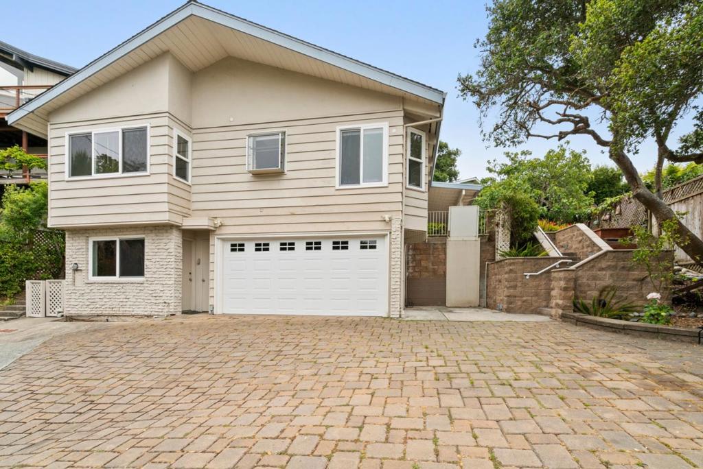 Opportunity knocks with this GEM that is just a short walk to Rio Del Mar beach! The property sits above the street for privacy, sunlight and stunning sunsets! Featuring 3 bedrooms, 2.5 bathrooms, 1471 sqft of living space and skylights in almost every room. The living room has a beautiful open-beam ceiling, wood-burning fireplace and wall of windows that opens to a spacious patio and is the heart of the home. The kitchen features an inviting eat-in dining area perfect for casual meals and gatherings. Bonus room off of the garage is ideal as a workshop/craftroom/office with a half bath. Sip your morning coffee as you take a peek of the ocean from the dining window. Priced with updates in mind, perfectly livable while adding your personal upgrades. Don't miss the opportunity to make this Aptos home your own.