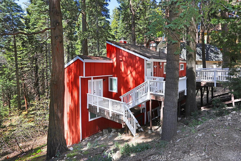 Beautifully Remodeled 4-Bedroom, 2.5-Bathroom Mountain Retreat. Nestled in the charming Arrowhead Villas area, this stunning remodeled home offers the perfect mountain escape. The main floor boasts a spacious kitchen and dining area with durable vinyl flooring, a convenient guest half-bath, and a cozy step-down living room featuring an electric fireplace and balconies with serene woodland views. One bedroom on this level opens to a front deck through elegant French doors. The second level includes a guest bedroom and a full bath, while the third level features the master suite, a laundry room, and a third guest bedroom with its own deck and breathtaking views of the woods. The front deck also provides parking for two cars. Located just minutes from Arrowhead Village, this property offers convenience and tranquility. Please note that it does not include lake rights. The quarterly $245 HOA fee, paid to Arrowhead Villas Mutual Company, covers road maintenance, snowplowing, trash service, and up to 200 gallons of water per day. Fully furnished and move-in ready, this home is a rare opportunity to own a slice of mountain paradise. Schedule your showing today and start enjoying the beauty of Lake Arrowhead!