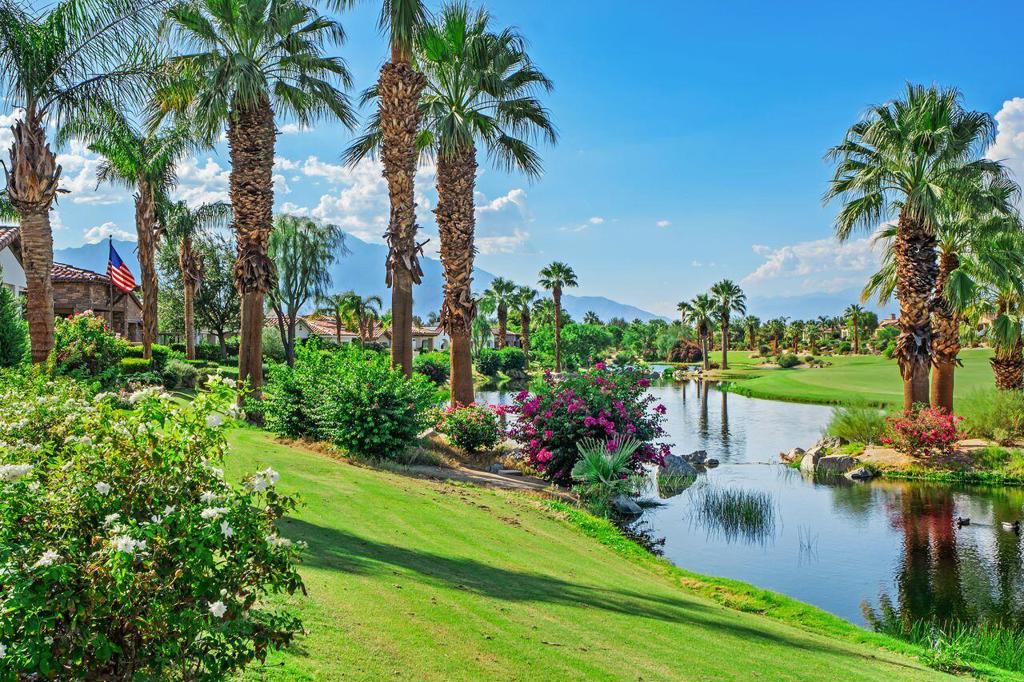 Welcome home to this beautifully remodeled Model 622, a 3,766 sq. ft. residence that embodies warmth, comfort, and elegance inside the prestigious gates of Toscana Country Club. With four bedrooms and four and a half baths, including a detached casita with its own sitting area, the home has been thoughtfully designed for both relaxation and entertaining.Set on a wide lot, this home offers one of the community's premier vantage points, showcasing sweeping views of the Jack Nicklaus-designed North Course, tranquil lakes, and dramatic mountain ranges beyond. The setting combines the serenity of nature with the prestige of a world-class golf community.Inside, soaring ceilings and expansive glass doors fill the great room with natural light and connect seamlessly to the outdoors. The kitchen features new luxury appliances, a generous island, sleek countertops, and custom cabinetry, while the dining area captures golf and lake views. The primary suite serves as a private retreat with expansive windows, a spa-inspired bath, dual vanities, soaking tub, and glass-enclosed shower. Each guest room is en suite, and the detached casita offers an ideal private space for family or friends.Outdoor living is central to desert life, and this home delivers. The backyard offers a sparkling pool and spa, built-in kitchen, and expansive entertaining spaces overlooking the course and lakes. The front courtyard adds another inviting space with a fireplace, water feature, and private putting green.Additional upgrades include owned solar panels, a three-car garage with air conditioning, and a whole-home water filtration system.Blending luxury and comfort, this Model 622 residence offers a rare opportunity to enjoy the desert lifestyle in one of Indian Wells' most exclusive communities.