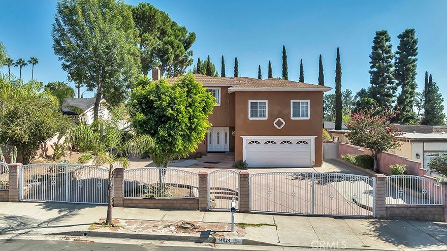 Rare Find in the Foothills of Sylmar - Multigenerational Living at Its Best! Welcome to this privately gated two story home, ideally nestled in the serene foothills of Sylmar. Offering over 3,000 sq. ft. of versatile living space on an expansive approx. 11,000 sq. ft. lot, this property is a perfect blend of comfort, functionality, and entertainment potential. The main residence features 4 spacious bedrooms and 2.5 bathrooms, with all bedrooms located upstairs for added privacy. The primary suite is complete with view balcony, walk-in closet, and updated ensuite bathroom featuring a granite vanity and tiled shower. Secondary bedrooms are generously sized, each offering peaceful treetop views. Step inside to find a welcoming interior adorned with newer wood laminate flooring, scraped ceilings, and dual fireplaces – one in the living room and another in the cozy family room. The tiled kitchen has tons of cabinet space, an adjacent dining area, and there's a bonus enclosed patio with French doors, two ceiling fans, and flexible space for entertaining, a home office, gym, or playroom. Enjoy year-round comfort with dual pane windows, central air & heat, and the convenience of an indoor laundry area. The attached two-car garage offers direct access, while a large circular driveway provides additional parking, including RV potential. Step outside to an entertainer’s dream backyard, featuring a spacious patio, built-in BBQ, and a sparkling swimming pool—perfect for family gatherings or weekend get-togethers. But that’s not all—this home also includes a wonderful guest unit (permitted as a recreation room) with its own private side entrance. This space includes a living room, kitchen, 2 bedrooms, and 1 bathroom, offering an ideal solution for extended family, guests, or even rental potential. Located with easy access to the 210, 118, 5, and 405 freeways, as well as nearby parks, shopping, and schools, this home is a rare opportunity for buyers seeking space, flexibility, and location. Don’t miss this unique opportunity to own a one-of-a-kind property offering true multigenerational living!
