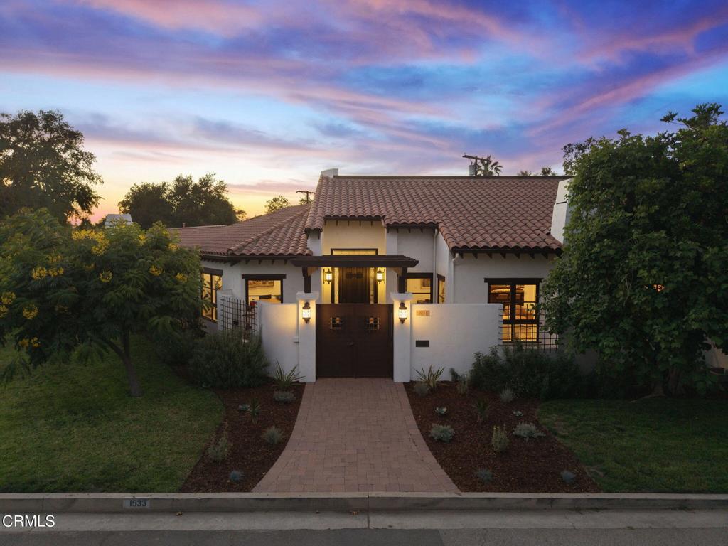 Exceptional Spanish Hacienda Equestrian Estate thoughtfully reimagined through a significant rebuild into a luxurious private retreat - crafted for effortless indoor-outdoor living, quiet luxury, and an ideal setting for both intimate gatherings and grand-scale entertaining. Beyond wrought iron doors, a private courtyard with a tranquil fountain sets the tone for the serenity and grandeur that await. Inside, a breathtaking great room is defined by soaring vaulted ceilings and sweeping sightlines that flow gracefully through the living, dining, and kitchen spaces. Oversized windows and French doors fill the interior with natural light and offer a harmonious indoor-outdoor living experience. At the heart of the home, a magazine-worthy chef's kitchen stuns with a grand center island, rich custom cabinetry, and dramatic earth-toned, veined single-slab counters and backsplash. A stunning row of transom-topped casement windows adds architectural interest and bathes the space in soft, ambient light. Created for the serious culinary enthusiast, the kitchen is equipped with a professional-grade Wolf range, full-size built-in refrigerator and freezer columns, dual-zone wine fridge, multiple sinks, and a generous walk-in butler's pantry. A pass-through window provides seamless service to the outdoor dining area--perfect for entertaining in style. Privately situated at the end of a light-filled corridor lined with French doors, the primary suite offers peaceful backyard views. Centered around a custom-tiled fireplace, the suite provides a quiet, comfortable retreat with space to lounge and unwind, and its own private outdoor access. The spa-inspired bath showcases a jetted soaking tub with serene views, a frameless walk-in shower with mosaic accents and built-in bench, and a custom vanity with natural stone countertops, ample storage, and a dedicated seating area. A spacious custom walk-in closet completes the suite. French doors throughout the home invite you to a sweeping covered veranda thoughtfully designed with multiple zones for open-air dining, relaxed lounging, and effortless entertaining - all overlooking the private backyard retreat. Equestrian amenities include a 1,400 sf, 5-stall barn with tack room and bathroom. Enjoy direct trail access to Griffith Park, nearby public riding arenas, close proximity to top schools, the Americana, and major studios.
