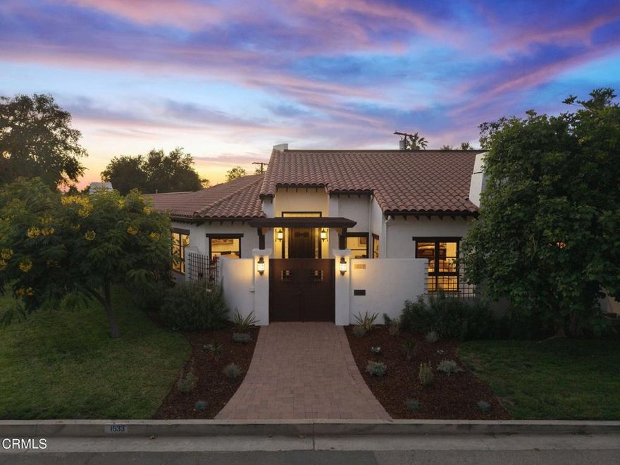 Exceptional Spanish Hacienda Equestrian Estate thoughtfully reimagined through a significant rebuild into a luxurious private retreat - crafted for effortless indoor-outdoor living, quiet luxury, and an ideal setting for both intimate gatherings and grand-scale entertaining. Beyond wrought iron doors, a private courtyard with a tranquil fountain sets the tone for the serenity and grandeur that await. Inside, a breathtaking great room is defined by soaring vaulted ceilings and sweeping sightlines that flow gracefully through the living, dining, and kitchen spaces. Oversized windows and French doors fill the interior with natural light and offer a harmonious indoor-outdoor living experience. At the heart of the home, a magazine-worthy chef's kitchen stuns with a grand center island, rich custom cabinetry, and dramatic earth-toned, veined single-slab counters and backsplash. A stunning row of transom-topped casement windows adds architectural interest and bathes the space in soft, ambient light. Created for the serious culinary enthusiast, the kitchen is equipped with a professional-grade Wolf range, full-size built-in refrigerator and freezer columns, dual-zone wine fridge, multiple sinks, and a generous walk-in butler's pantry. A pass-through window provides seamless service to the outdoor dining area--perfect for entertaining in style. Privately situated at the end of a light-filled corridor lined with French doors, the primary suite offers peaceful backyard views. Centered around a custom-tiled fireplace, the suite provides a quiet, comfortable retreat with space to lounge and unwind, and its own private outdoor access. The spa-inspired bath showcases a jetted soaking tub with serene views, a frameless walk-in shower with mosaic accents and built-in bench, and a custom vanity with natural stone countertops, ample storage, and a dedicated seating area. A spacious custom walk-in closet completes the suite. French doors throughout the home invite you to a sweeping covered veranda thoughtfully designed with multiple zones for open-air dining, relaxed lounging, and effortless entertaining - all overlooking the private backyard retreat. Equestrian amenities include a 1,400 sf, 5-stall barn with tack room and bathroom. Enjoy direct trail access to Griffith Park, nearby public riding arenas, close proximity to top schools, the Americana, and major studios.