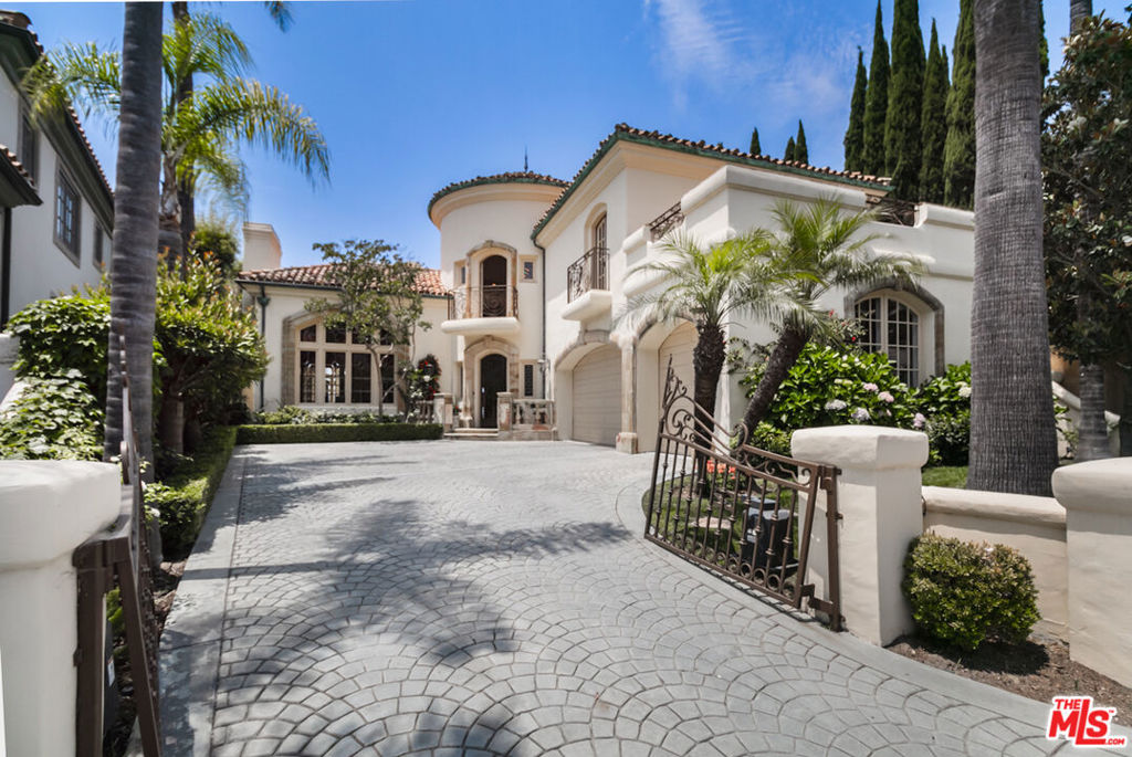 Stunning Custom gated villa with gorgeous ocean and mountain views. Designed by renowned architect Ron Firestone with amazing quality and attention to detail featuring voluminous rooms and soaring ceilings both upstairs and downstairs. Gated driveway leads you to this custom masterpiece w/ 5 bedrooms suites and high-end finishes. Dramatic 2-story entry welcomes you with limestone floors and a circular staircase. Wood-finished library has 2-story ceilings and custom bookcases. The house is full of light with soaring windows and plenty of French doors to utilize that backyard. Huge family room with walk-around wet bar and oversized fireplace. Gorgeous backyard with pool, spa and lush gardens featuring stunning mountain and ocean views, BBQ area with a great sense of privacy. Large family kitchen w/ island, breakfast area, and stainless appliances. Formal living and dining rooms. Additional bedroom suite down. A dramatic circular staircase takes you upstairs with 4 large bedroom suites. Luxurious primary suite with sweeping views, gorgeous marble bath and a pvt sitting area. The front bedroom features wood floors and a huge private deck. One guest bedroom is large enough to be a second primary! 3-Car attached garage and additional off-street parking in the gated driveway. This is a one-of-a-kind custom home with unsurpassed quality and sophistication.