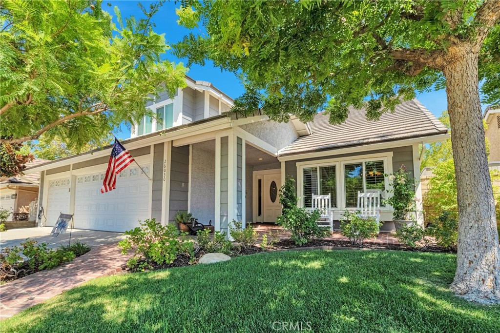 Perfectly situated on a private cul-de-sac in the desirable Heritage community, this beautifully renovated Westport model is just steps from award-winning Valencia Valley Elementary. A pristine exterior and custom leaded-glass entry set the stage for the stylish updates inside. The kitchen is the heart of the home, showcasing raised-panel cabinetry, granite counters, a striking new backsplash, pantry, and tile flooring. It opens seamlessly to the inviting family room with an upgraded fireplace and recessed lighting. Formal living and dining rooms feature vaulted ceilings, a sweeping staircase, and abundant natural light—ideal for gatherings. A downstairs bedroom with adjacent remodeled bath offers flexible living or office space. Upstairs, the primary suite boasts a warm brick fireplace, spacious walk-in closet, and spa-like bath with a freestanding soaking tub, dual vanities, and glass-enclosed shower. Two additional bedrooms share a remodeled Jack-and-Jill bath, while the convenient upstairs laundry (rare for this floor plan!) adds everyday ease. Additional upgrades include 8mm engineered hardwood flooring, all-new fixtures, refinished bannisters with iron balusters, and upgraded 10-inch HVAC ductwork for enhanced airflow. Outdoor spaces are equally impressive, featuring new hardscape, a covered patio with recessed lighting and ceiling fans, plus a three-car garage with epoxy floors and built-ins. Plantation shutters, dual-pane windows, copper plumbing, and a newer HVAC system add lasting value. The HOA offers low monthly dues with access to three community pools and spas, multiple parks, and scenic paseo trails. Shopping, dining, and freeway access are just minutes away—and best of all, NO Mello Roos! Welcome home to 26030 Tampico Drive!