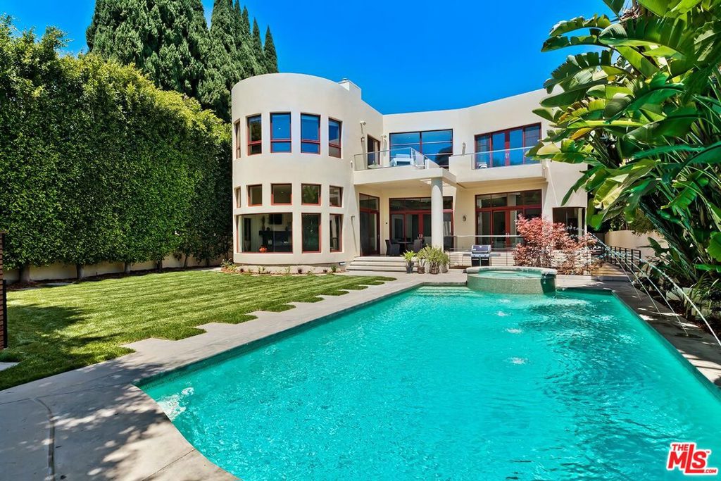 Stunning 2007-built 3-level Modern on a coveted Westend Flats road moments from the creme de la creme of the Westside. Dramatic sunlit spaces with super high ceilings, artistic stairwell, glass walls, curvature, wood floors. Mammoth Great Room with a 2 story ceiling overlooks lush gardens with pool, spa, patios, lawns, mature privacy foliage. Separate office/study and large family room with fireplace. Superb cook's kitchen with top appliances and generous pantry. Big upstairs landing/lounge area leads to 4 generous bedroom suites including a huge master with sitting area, fireplace, balcony with city light vistas, luxe bathroom, and big walk-in. Lower level consists of massive open entertaining spaces with bar, gym (possible 5th bedroom), and a fabulous outdoor patio. Gated parking and a direct-entry garage for privacy and security. Combine all of this with intense architectural curb appeal and you have a true gem on Walden Drive.