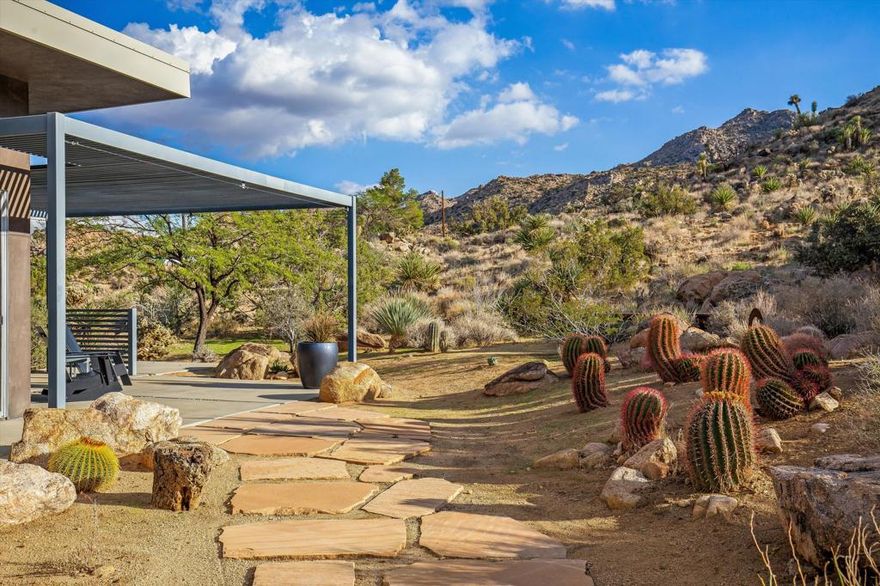 Nestled in the prestigious neighborhood of Joshua Tree Highlands, a unique opportunity to own a 2+ acre compound boasting two modern homes awaits. The main home was built in 2010, and the guest house followed shortly after in 2014, both by famed local builder David Eckenroth. Peace and tranquility, just minutes from the National Park's west entrance gate. The main house is a blank canvas ready to be transformed into your dream retreat. With an open-concept layout, sleek concrete floors, lofty ceilings, and outdoor shower, the space awaits your design direction and showcases panoramic views in every direction. The guest home offers privacy and versatility, with its own deck showcasing awe-inspiring views and outdoor bathing under the stars. Inside, custom cabinetry and polished concrete floors echo the main house's contemporary footprint. This space serves as an ideal guest suite, art studio, or office, just waiting for the finishing touches to be added. Immerse yourself in the quiet and serene ambiance of Joshua Tree, with expert planting of intentional and curated desert vegetation, iconic desert topography including boulders and Joshua trees. This compound is a true escape, offering endless potential for investors, artists, or anyone seeking a modern sanctuary in the desert.