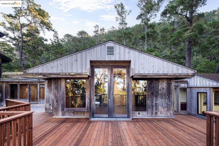 This extraordinary Carmel Highlands is a rare offering steeped in history, artistry and timeless coastal beauty. Designed to live flexibly, the home can be enjoyed as two or three separate units or one expansive family retreat.  Originally built as a 915 sq ft cabin, the home was thoughtfully expanded in 1975 with a striking architectural addition designed by Peter Lee and crafted by master builder Stephen Trapkus alongside the current family who have cherished it for over 50 years. The result is a soulful blend of rustic charm and architectural elegance, where soaring wood-beamed ceilings, rich hardwood floors, and walls of glass frame sweeping wooded and peek-a-boo ocean views. Natural light floods every room, creating warm and inviting interiors that harmonize with the surrounding redwoods, Monterey pines, and rugged coastline. Carmel Highlands itself has a storied legacy, envisioned in 1915 by Frank Devendorf as a creative haven for artists, writers, and sculptors. Now enhanced with modern amenities, including high-speed internet for those seeking both seclusion and connectivity. This property embodies the magic of Carmel Highlands where history, art, and nature converge. Private Beach Access! Welcome Home!