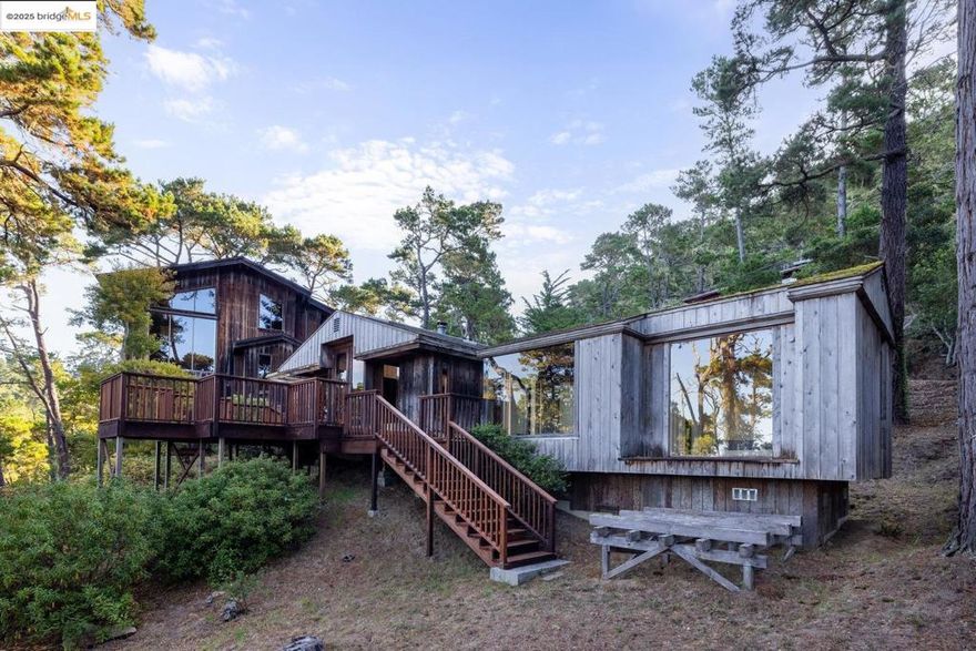 This extraordinary Carmel Highlands home is a rare offering steeped in history, artistry, and timeless coastal beauty. Originally built as a 915 sq ft cabin, the home was thoughtfully expanded in 1975 with a striking architectural addition designed by Peter Lee and crafted by master builder Stephen Trapkus alongside the current family who have cherished it for over 50 years. The result is a soulful blend of rustic charm and architectural elegance, where soaring wood-beamed ceilings, rich hardwood floors, and walls of glass frame sweeping views of Point Lobos and unforgettable sunsets over the Pacific. Designed to live flexibly, the home can be enjoyed as two or three separate units or one expansive family retreat. Natural light floods every room, creating warm and inviting interiors that harmonize with the surrounding redwoods, Monterey pines, and rugged coastline. Carmel Highlands itself has a storied legacy, envisioned in 1915 by Frank Devendorf as a creative haven for artists, writers, and sculptors. Now enhanced with modern amenities, including high-speed internet for those seeking both seclusion and connectivity. This property embodies the magic of Carmel Highlands where history, art, and nature converge. Private Beach Access! Welcome Home!