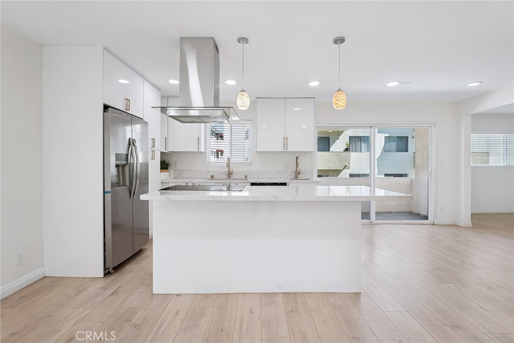 Beautifully Upgraded 2+2 End Unit Condo with Bonus Room in Prime Encino Location! Welcome to this light-filled and stylishly remodeled end-unit condo located in the desirable Encino Terrace community. This spacious 2-bedroom, 2-bathroom home also includes a versatile bonus room—perfect for a home office, den, or easily convertible into a third bedroom, complete with a wall-to-wall custom built-in closet. The open-concept layout features a chef-inspired kitchen with a large island, quartz countertops, stylish cabinetry, double sinks, stainless steel appliances, and a sleek range hood. The kitchen flows seamlessly into the dining and living areas, creating a perfect space for entertaining. Natural light floods the unit, highlighting the brand-new flooring and recessed lighting throughout. The primary suite is spacious and bright, with a beautifully upgraded en-suite bathroom offering double sinks, a walk-in shower, and a custom walk-in closet. The secondary bedroom includes a built-in desk and its own custom closet, with a full bathroom conveniently located nearby. Additional highlights include dual-pane windows, updated finishes throughout, and two covered tandem parking spots with storage, located close to the unit. Enjoy the resort-style amenities of Encino Terrace, including two pools, a spa, gated entry, and two community laundry rooms—one just steps away from your door. Ideally located just off Ventura Blvd, you’re minutes from top restaurants, shopping, and easy freeway access. This turnkey unit combines comfort, function, and location—don’t miss this incredible opportunity to own in the heart of Encino!