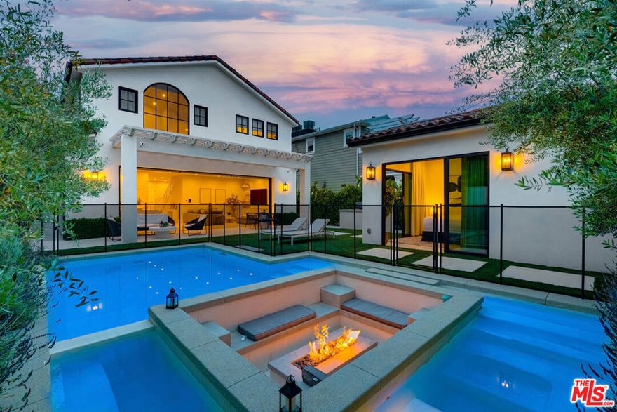 This property is available for short-term and long-term rentals, each with its respective pricing options. It is fully furnished, decorated, and equipped with hotel-like essentials and amenities. With our concierge team available to assist 24/7, this home rental offers a five-star hospitality experience, whether you are staying for a few days, a month, or a year. This residence is a serene retreat in one of LA's most sought-after areas, blending comfort, elegance, and opportunity. Featuring five spacious bedrooms and five and a half luxurious bathrooms, the Mediterranean-style villa showcases timeless design with white stucco walls, terracotta roof tiles, and modern black-framed windows. Hardwood floors flow throughout, with natural light pouring into the inviting living spaces. Large sliding doors connect the indoors with the beautifully landscaped outdoor area, which includes a serene pool, fire pit lounge, and manicured lawn. Located near top schools, trendy shops, and gourmet dining, this home offers both tranquility and vibrant city living.