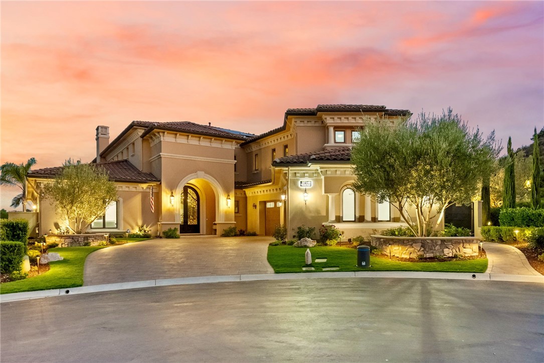 Welcome to this Exceptional custom home in Bear Creek boasting stunning views of the par five 11th hole and the signature par three 12th hole of the Jack Nicklaus designed golf course. This 6,028 sq. ft. estate showcases 4 bedrooms, 7 baths, an executive office with built ins, a huge loft/game room with wet bar and entertainment center, and an ADA compliant elevator. The grand entry welcomes you through double iron doors into a dramatic foyer with 25’ ceilings, leading to a magnificent living room with vaulted ceilings and a 6’ fireplace. The formal dining room features a climate controlled wine cellar with storage for 600 bottles, creating the perfect setting for elegant entertaining. The gourmet kitchen is designed for the culinary enthusiast with an enormous center island, SubZero refrigerator, 6-burner stove plus griddle, three ovens, two warming drawers, dual dishwashers, pot filler, microwave, double sinks, large walk in pantry, and butler’s pantry. The luxurious primary suite offers curved windows, soffit lighting, marble surfaces, travertine flooring, Jacuzzi tub, oversized shower with 10 shower heads, and an enormous custom closet with built-in shoe racks. Upstairs are two spacious ensuite bedrooms with large walk in closets, a sprawling game room with pool table and built ins, and a covered patio with fireplace overlooking the golf course. The private office features wood flooring, coffered ceiling, and built in desks and shelving. Resort style amenities include a Pebble Tec pool and spa with Ozone water filtration, outdoor kitchen, oversized 3 car garage with insulated doors, epoxy flooring, and abundant storage. Modern upgrades include surround sound, central vacuum, water softener, reverse osmosis system (HALO), custom window coverings with electric shades, electric outdoor screens, and high end finishes throughout including granite and onyx countertops and travertine flooring. Since ownership, the home has been extensively enhanced with new pavers in the front, back, and sides of the home including the driveway, fresh interior and exterior paint, landscaping in both the front and back with slope improvements facing the golf course, a wine cellar cooling system, 3 new HVAC systems with ductwork and clean air (HEPA) filtration, and a paid off 13.5 KWH solar system with 40+ panels and 5 storage batteries. With timeless design, modern efficiency, and some of the best views Bear Creek has to offer, this estate is truly one of a kind.