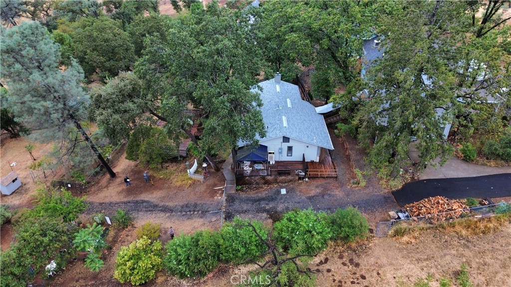 Picture perfect sunsets with a tree house feel! This charming home captures that old saying "Follow me home, I'll show you Paradise!" Plenty of room for all your animals, gardening projects, afternoon BBQing on the deck or just relaxing in the peace & quiet reading your favorite book! With over 2500 sq ft of living space, you'll have room to grow or entertain special guests. Each spacious bedroom has an exit door & also has it's own bathroom. Tucked away on 1.34 acres with the option of purchasing the 1.98 acres next door, you'll have an opportunity to create a one-of-a-kind setting. The welcoming entry leads you to an oversized living room lined with large windows overlooking the property. You'll appreciate the brick hearth with woodstove for keeping cozy & warm during the winter. A step down kitchen and dining area are close by offering plenty of room for preparing to serve & welcome your guests. Just off the dining area is a private office with a half bath. The master bedroom is huge and offers a private balcony & large windows allowing lots of light in and even picturesque views of evening sunsets. As you wind down the staircase to the guest bedrooms, you'll find a large foyer that leads outside to the backyard space. Each bedroom downstairs is spacious and has a private bathroom attached. There is also a large laundry room with storage space. You'll appreciate the finished garage space with room for 2 vehicles. Above the detached garage space, there is an enormous room that could be used as a shop, craft space, storage area, game room, etc. There is so much to offer throughout this entire property, it requires you to see it all in person. Make an appointment today to see this truly unique home & acreage!
