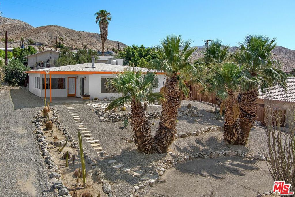 This cozy mid-century modern hilltop home has been gorgeously remodeled in the style of its origin. This 2BR 1BA home is at the top of Desert Hot Springs Highlands (Miracle Hill) with sweeping views of the Coachella Valley. This property is in the Spa Zone, perched in a quiet neighborhood with plenty of privacy. Fans of this period of architecture will appreciate the cactus and queen palm landscaping, the picture window and the apricot glow orange trim, the funky decorative fireplace, the high quality new floors, fully remodeled kitchen with orange tile backsplash, and original wood built-in cabinets and doors. Built in 1961 it has a flat roof typical of desert modernist houses, with good insulation and powerful central AC, period light fixtures, newly remodeled bathroom with deep soaking tub and modern toilet. Washer/Dryer, gas range and Refrigerator included. Fenced in back yard with privacy landscaping and a sail shade. Concrete-floored "bonus room" with a bar! 17 min. to downtown Palm Springs. Actual square footage is bigger with the bonus sun room. Available for 12 month lease.