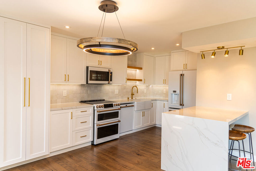 Welcome to 970 Palm Ave, Unit 306, Bathed in natural light, this sophisticated south-facing residence redefines elevated living. Perched on the top floor with sweeping city views, the home features an open concept design that seamlessly blends elegance and functionality. The gourmet kitchen is a statement of refined taste accompanied by striking quartz countertops, a designer-tiled backsplash, and Cafe line appliances complemented by gold-accented hardware. Every detail exemplifies modern luxury with timeless appeal. Resort inspired amenities extend your living space outdoors, with an eight-foot-deep pool, soothing spa, and a beautifully appointed BBQ area ideal for sun-soaked afternoons or evening gatherings. Water and trash are included, allowing for effortless living. This residence is the perfect balance of design, comfort, and city sophistication.
