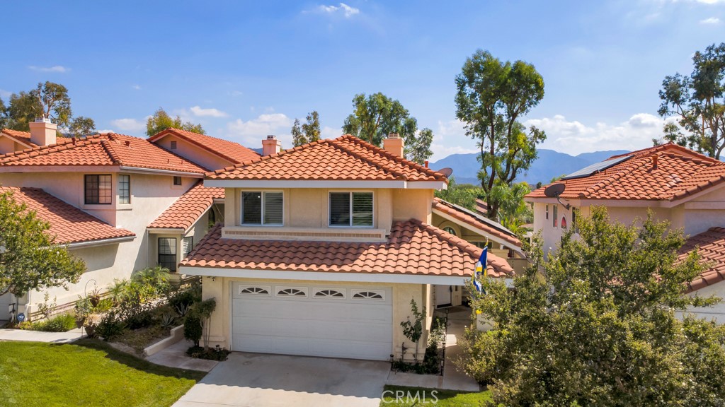 If you would like to own one of the most beautiful homes ever offered for sale in the wonderful "American Beauty Meadows" community, this is it! From the exquisite decor, the top-of-the line upgrades, the fabulous entertainer's backyard, to the scenic mountain views, this home is truly stunning! This two story home has lovely exterior appeal with professional landscaping, which is maintained by the HOA. The interior has a well designed floor plan with an elegant formal living room with vaulted ceilings, wood plank tiled flooring, custom shutters, and an adjoining formal dining area. The family room includes a beautiful fireplace with a custom surround made of natural "Quartzite" stone, along with wood plank tiled floors and indirect lighting. In the family room, you will also find a custom built-in work station/office with quality cabinets, a "Quartzite" desk top and a custom bar/eating area with a matching stone top. The outstanding remodeled kitchen has top quality cabinets and appliances, wood plank tiled floors, and custom "Quartzite" counter tops. Downstairs, there is also a lovely remodeled half bathroom and direct access to the two car garage. Upstairs, there is a fabulous master bedroom suite, two additional bedrooms, and a beautifully remodeled full bathroom. The spacious master suite has vaulted ceilings, a gorgeous remodeled bathroom with double sinks, a stylish tiled shower, and a large balcony with a beautiful mountain view and access to the pool from the spiral staircase. Note: there are wood plank tiled floors in all 3 bedrooms and the hallway. Outside, the backyard is fantastic, featuring a swim-spa and a separate spa, with a great custom deck, a built-in BBQ/kitchen, stuccoed block-wall fencing, and much more! Plus: a "paid for" solar system, copper plumbing, upgraded electrical panel, shutters through-out, except the master shower window, double pane windows, and much more! The community amenities include pools, a spa, and tennis courts close by. Enjoy a short trip to the serene Oak Spring Park for a picnic with your family and friends and don't miss the baseball diamond at the north end of Marilyn Dr. Also close by, is the newest shopping complex in the community, featuring Sprouts Market, Starbucks, Chipotle, and many other restaurants. And access to the 14 freeway is very close by for your commute, and there are also wonderful schools nearby. Hurry, this one will not last long!