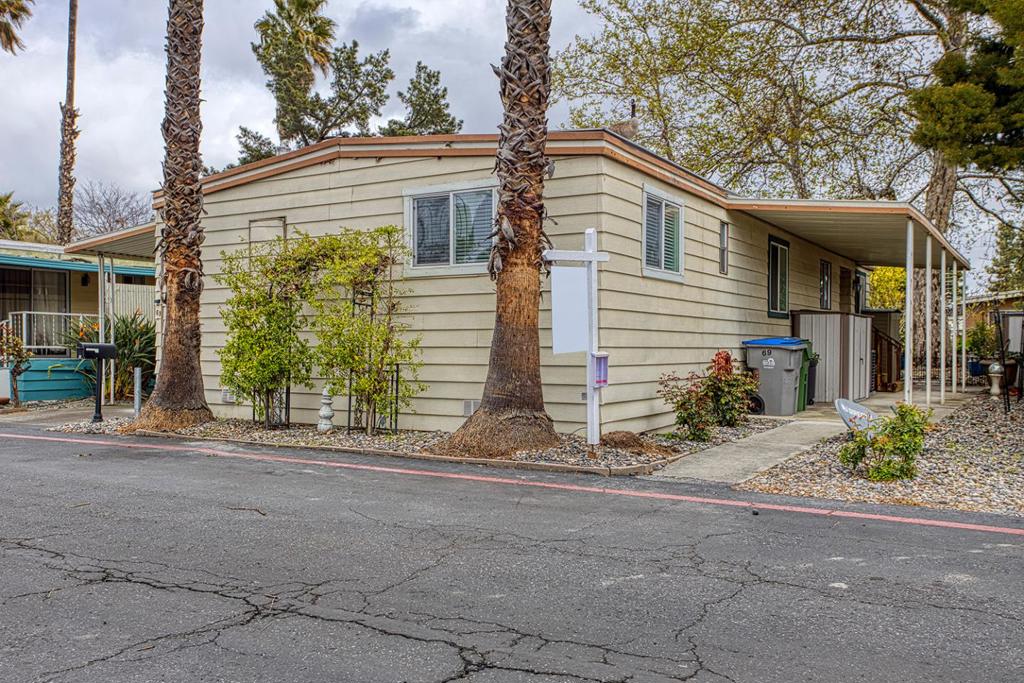 Beautiful home in a Family Friendly all age park in the heart of San Jose. Home is 1,344 sq ft with 3 bedrooms, 2 bathrooms and an open floor plan with a spacious living, dining & kitchen floor plan. Newly updated with plank floors throughout, freshly painted inside, beautiful kitchen with granite counter tops and nice appliances. Center island has extra storage and counter top space to spread out to cook. Laundry room has plenty of storage space, the washer & dryer will stay with the property. The large bonus enclosed carport room is perfect for storage, the front side walkway is spacious, leading to a backyard with wonderful views of the water fountain. Sliding door opens up to a spacious backyard with views of the lovely water features with Geese swimming by. Living room window has views of the back yard. 2 additional storage sheds come with the home for extra storage. Home is in a park that features a swimming pool, club house and gated for privacy. Come see before its SOLD!