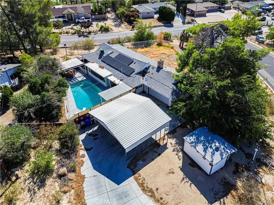 Ranch Style Single story home with over One acre lot - Sits high on a hill with an Amazing Panoramic Desert Sunset View from your Living Room - cozy Fireplace - 3 Spacious Bedroom-Remodeled Bathrooms and  Country Kitchen - Large enclosed Sun Room-Sparkling Pool.  Large Storage Shed. Concrete Driveway to  Oversized Multi Carport and attached 2 car garage. Auto Electric Security gate.