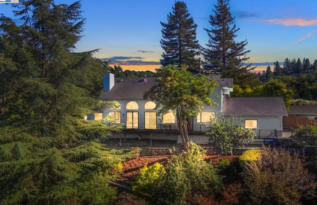 Tucked away on a quiet cul-de-sac, this beautifully rebuilt 4-bedroom, 2-office home offers a rare blend of space, versatility, and privacy on nearly an acre. Redesigned in 1997, it features soaring ceilings, a dramatic wall of windows, and sweeping hillside views—perfect for sunset cocktails or relaxed gatherings on the expansive deck. The main level includes a generous primary suite, a second office, a flexible bonus room, and a bright, airy kitchen with ample prep space, a large walk-in pantry, and easy indoor-outdoor flow. A spacious laundry room with dual washer/dryer sets and a half-bath add convenience. Upstairs, one bedroom enjoys an en-suite bath, while two others share a Jack-and-Jill layout—ideal for family or guests. Downstairs, a rare basement offers abundant storage or the potential for a wine cellar. The expansive lot offers endless opportunity: build an ADU, add a pool, sport court, garden beds, a chicken coop, or even a small hobby vineyard. There’s room to dream—and room to grow. Surrounded by mature landscaping, fruit trees, and total privacy, all just minutes from top-rated schools and vibrant downtown Lafayette.